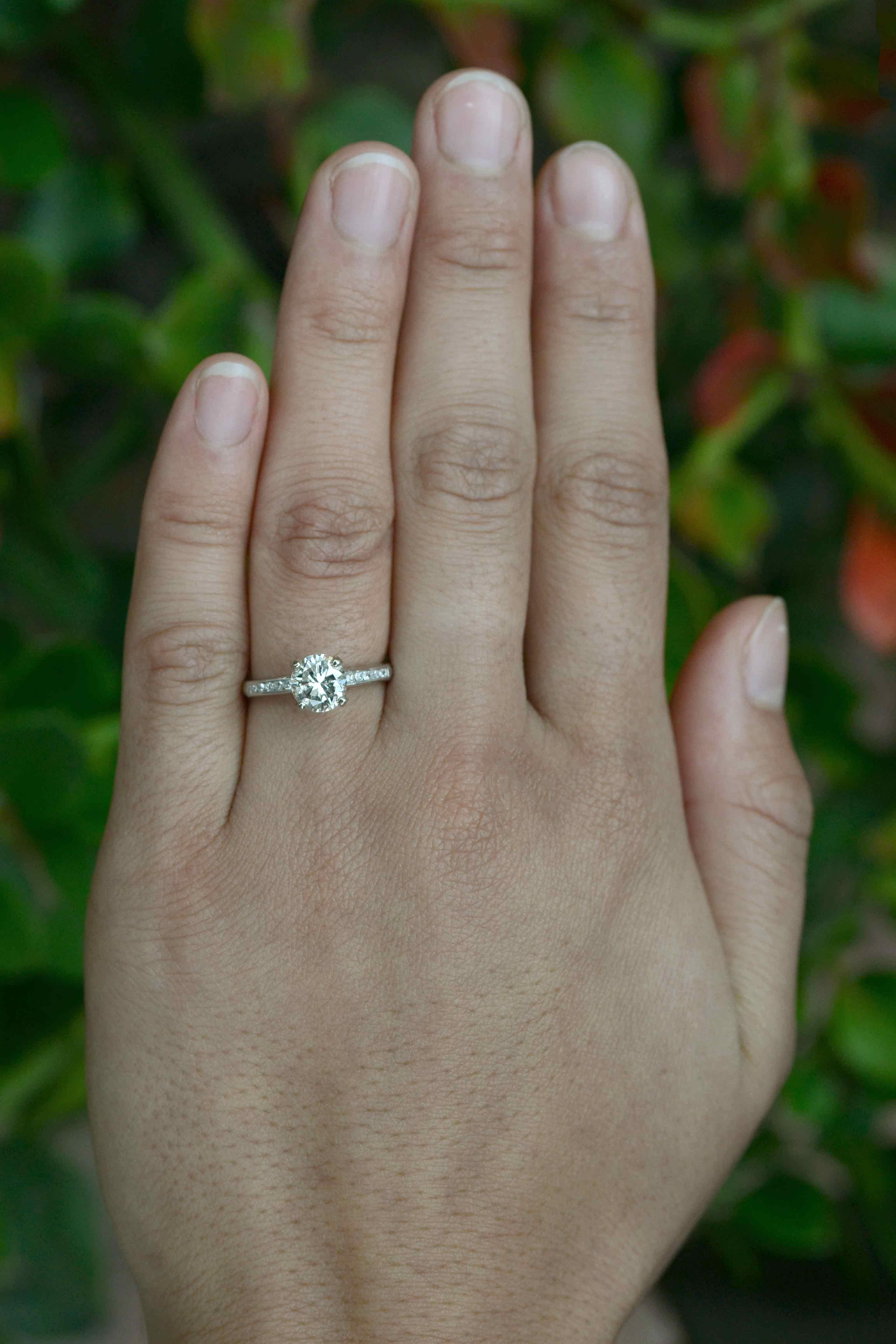 Abilene Vintage Mid Century 1960s diamond solitaire engagement ring. A timeless classic centering on a captivating, brilliant 1.27 Carat brilliant cut with a pleasing, warm, sparkling personality.

You'll love how the simple platinum band, adorned