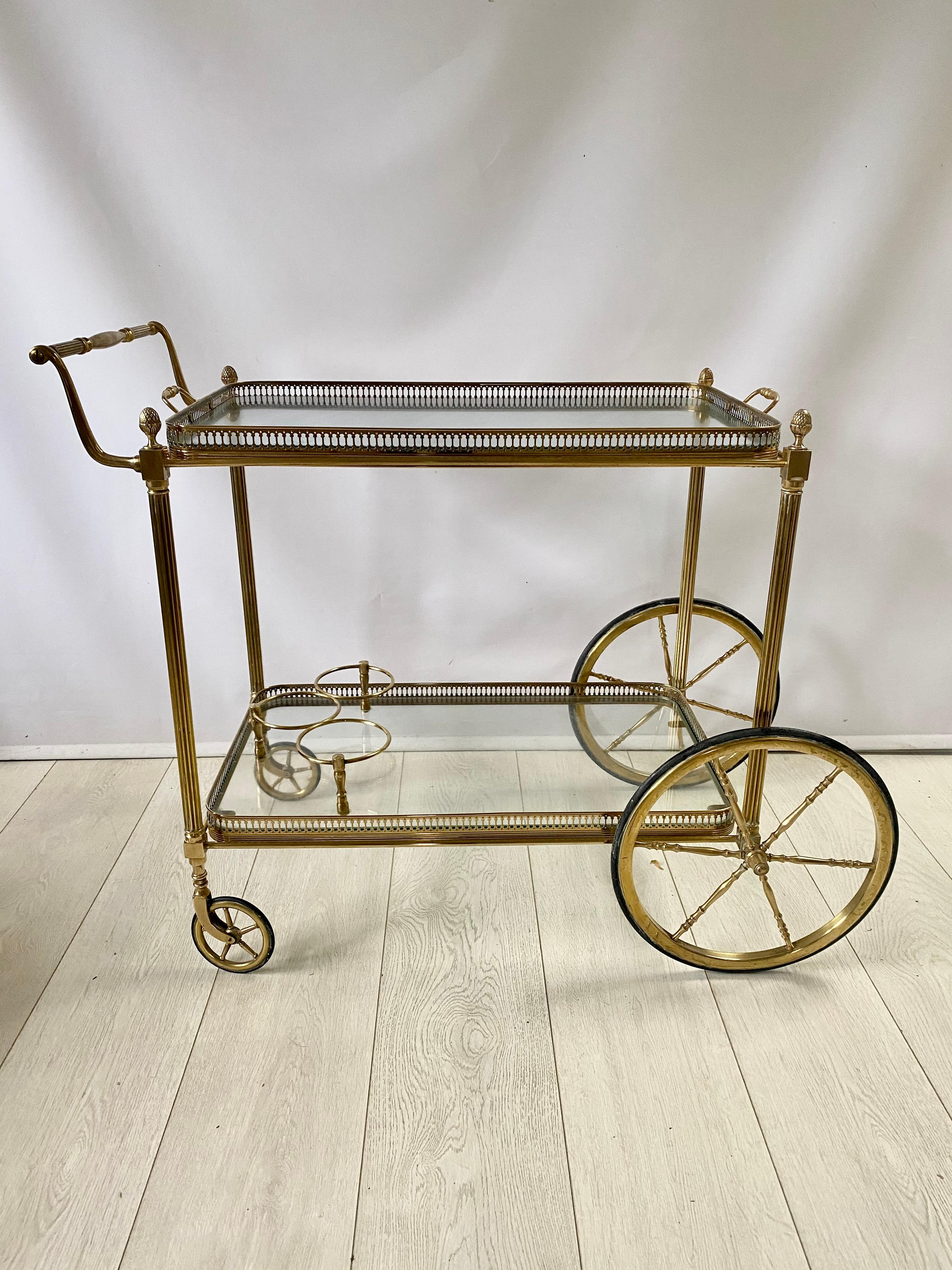 Quality French drinks trolley c1950

Generous in size with top tray measuring 62cm wide by 36.5cm deep, 60cm to glass.

Polished brass frame with lift off top tray and bottle holder to lower tray.

Overall dims 90 cm wide, 50 cm deep and