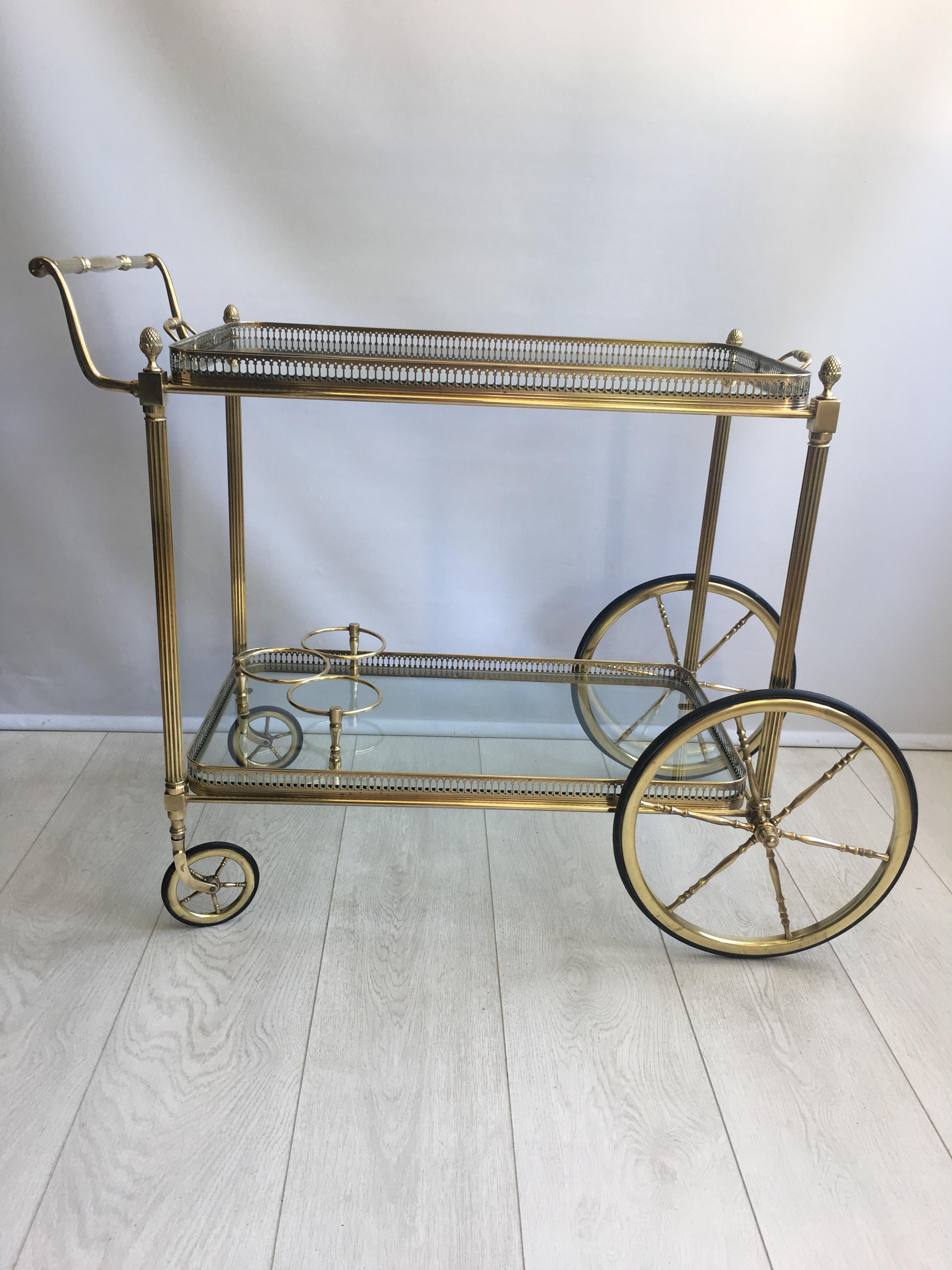 Classic French brass drinks trolley, circa 1950.

Great quality with polished brass frame and bottle holder to lower tier

Lift off tray measures 62.5 cm wide, 36.5 cm deep and stands 62 cm to glass.
Overall dims 85 cm wide, 48 cm deep and 71