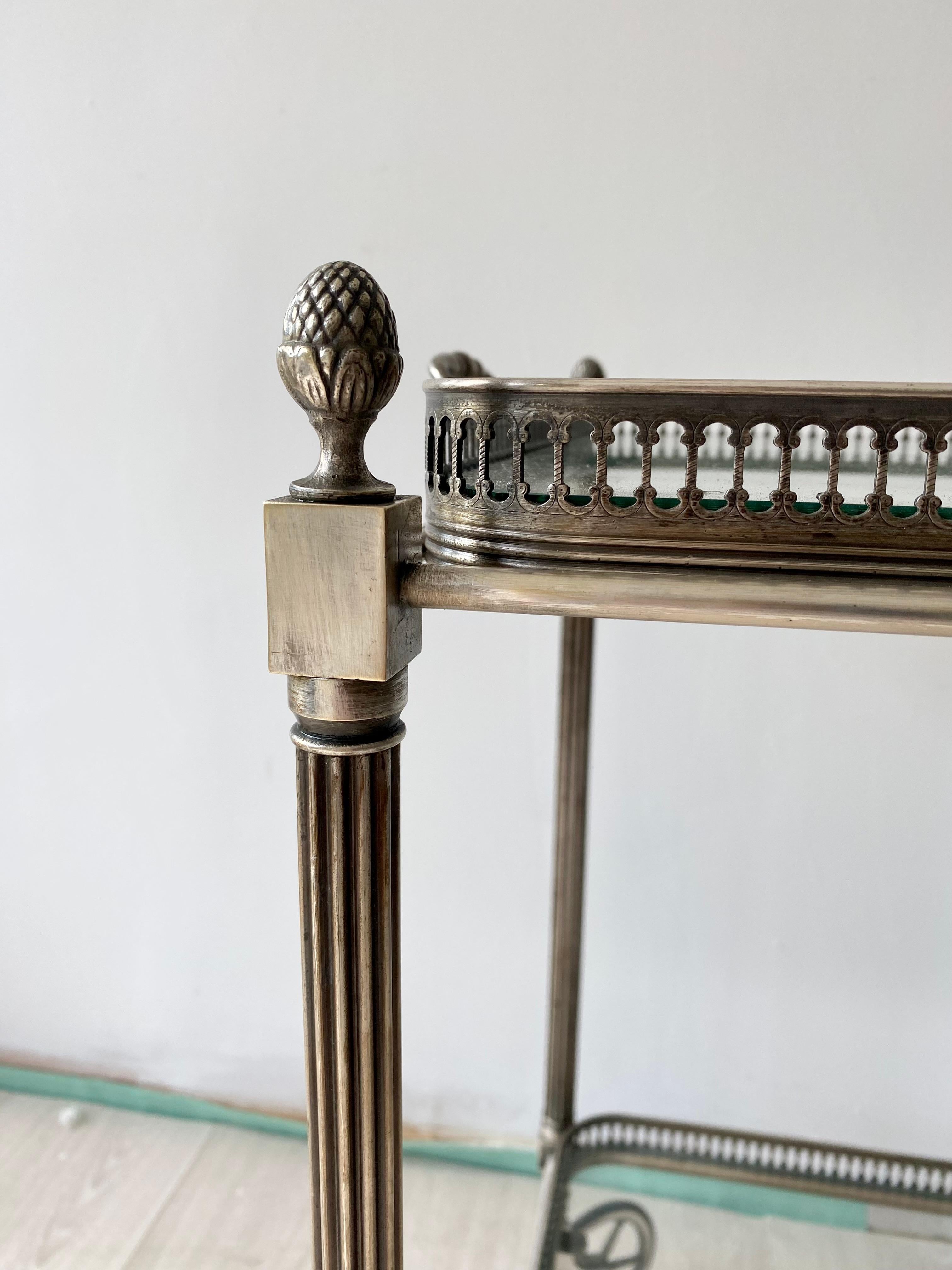 Quality French drinks trolley, circa 1950
Generous in size with top tray measuring 62cm wide by 36.5cm deep
Aged silver finish on a brass frame with lift off top tray and bottle holder to lower tray.
Overall dims 77cm wide, 40cm deep Stands 62cm to