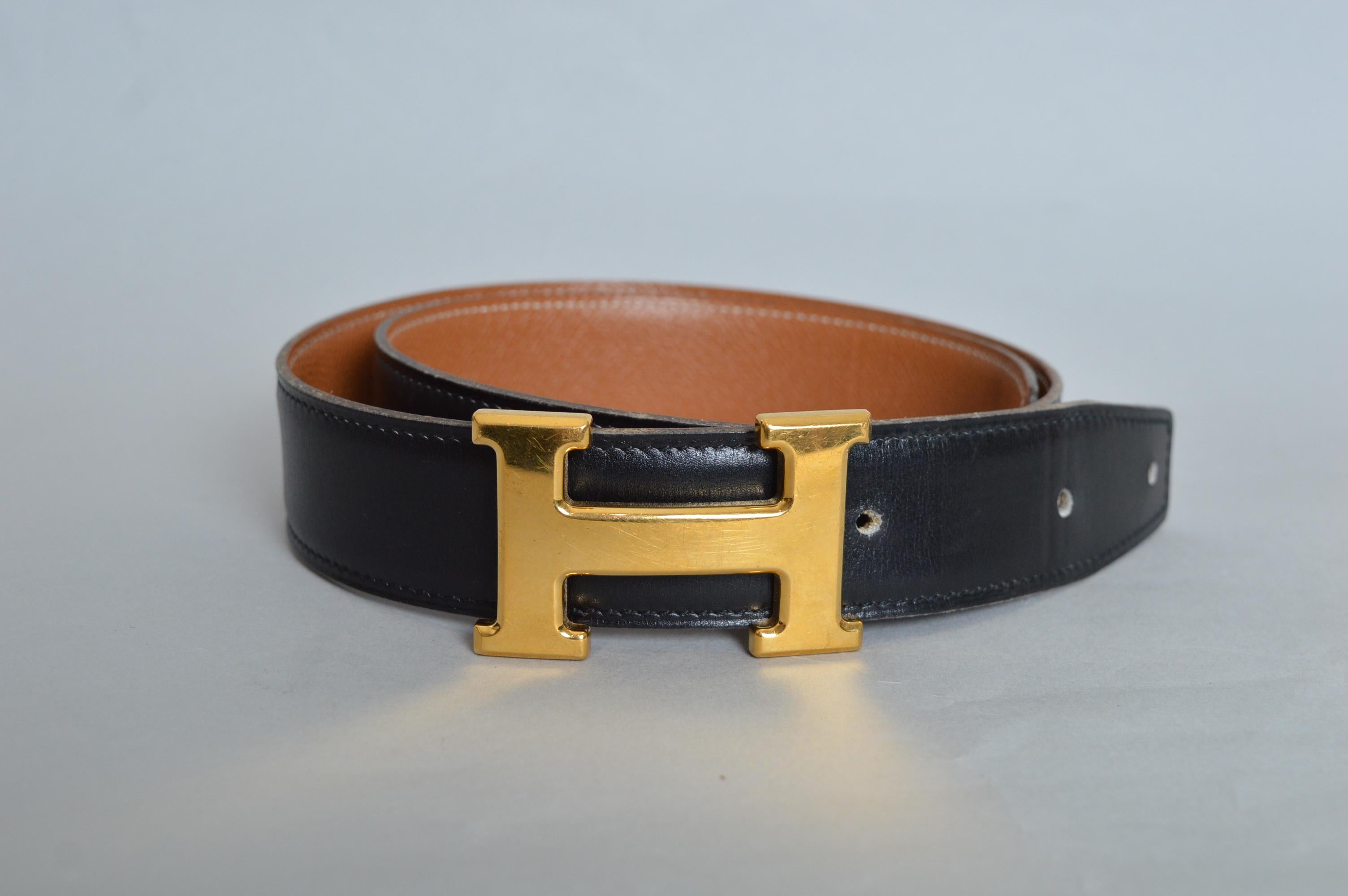 A Timeless Vintage HERMÈS Black leather Vintage Waist belt with adjustable moving buckle and tan gross-grain leather lined interior. 
The previous owner has had extra holes added to the belt to accommodate a wider variety of size options.  
Size;