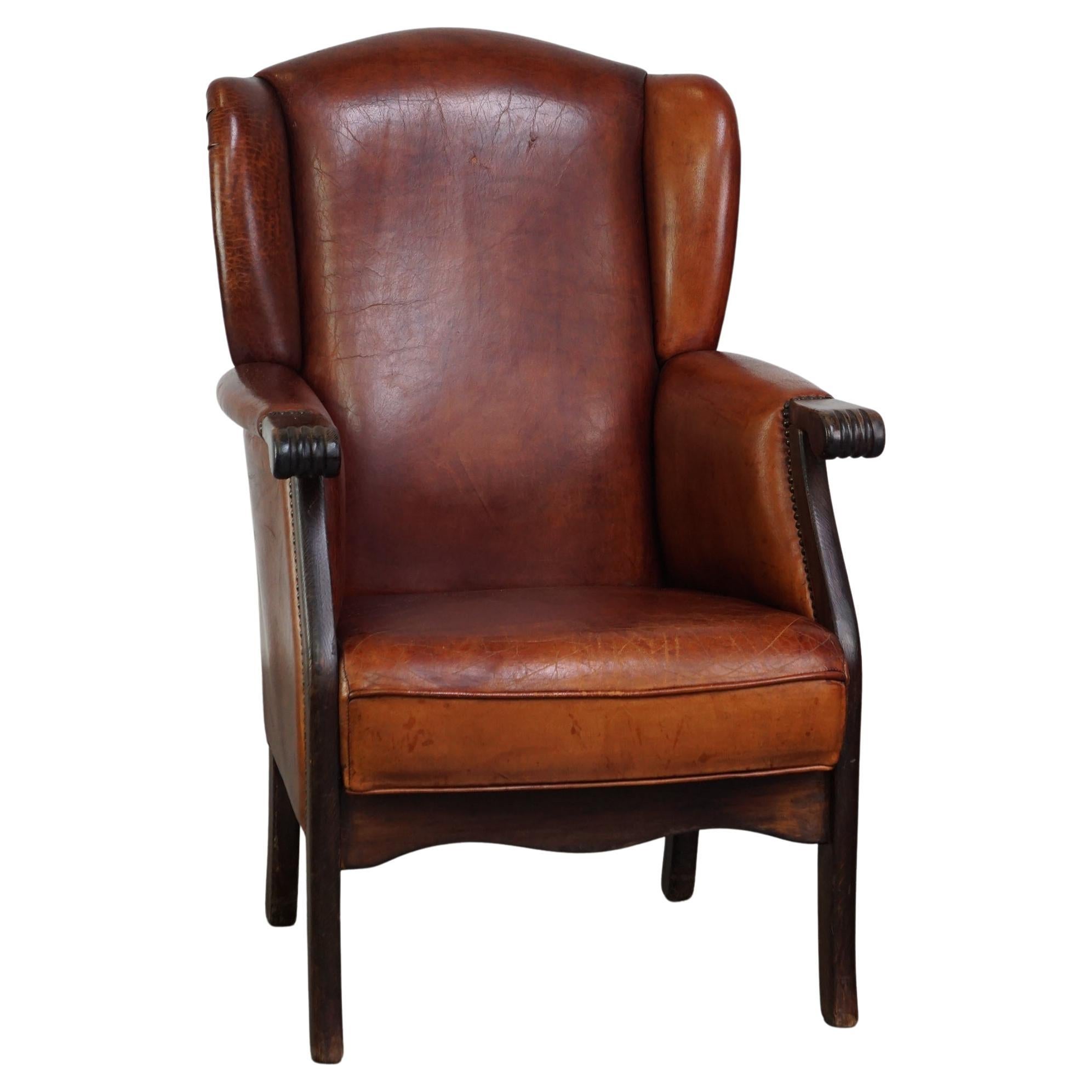 Classic vintage sheepskin wing chair with beautiful finish and warm colours