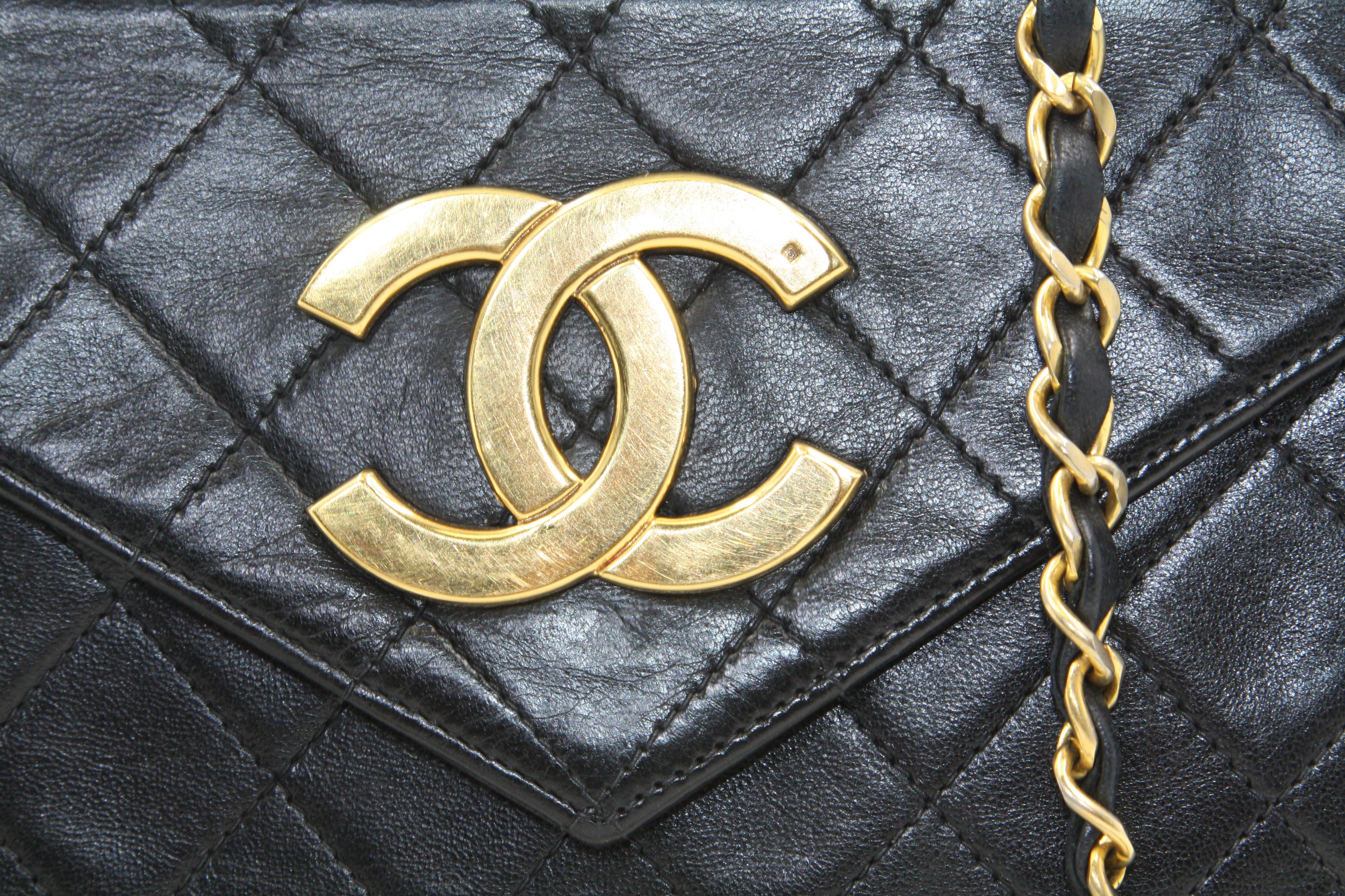 We guarantee this is an authentic CHANEL Vintage Lambskin Quilted small Single Flap Black Bag. This stylish vintage model is finely composed of supple diamond quilted lambskin leather in black. The bag features a waist-length polished gold chain