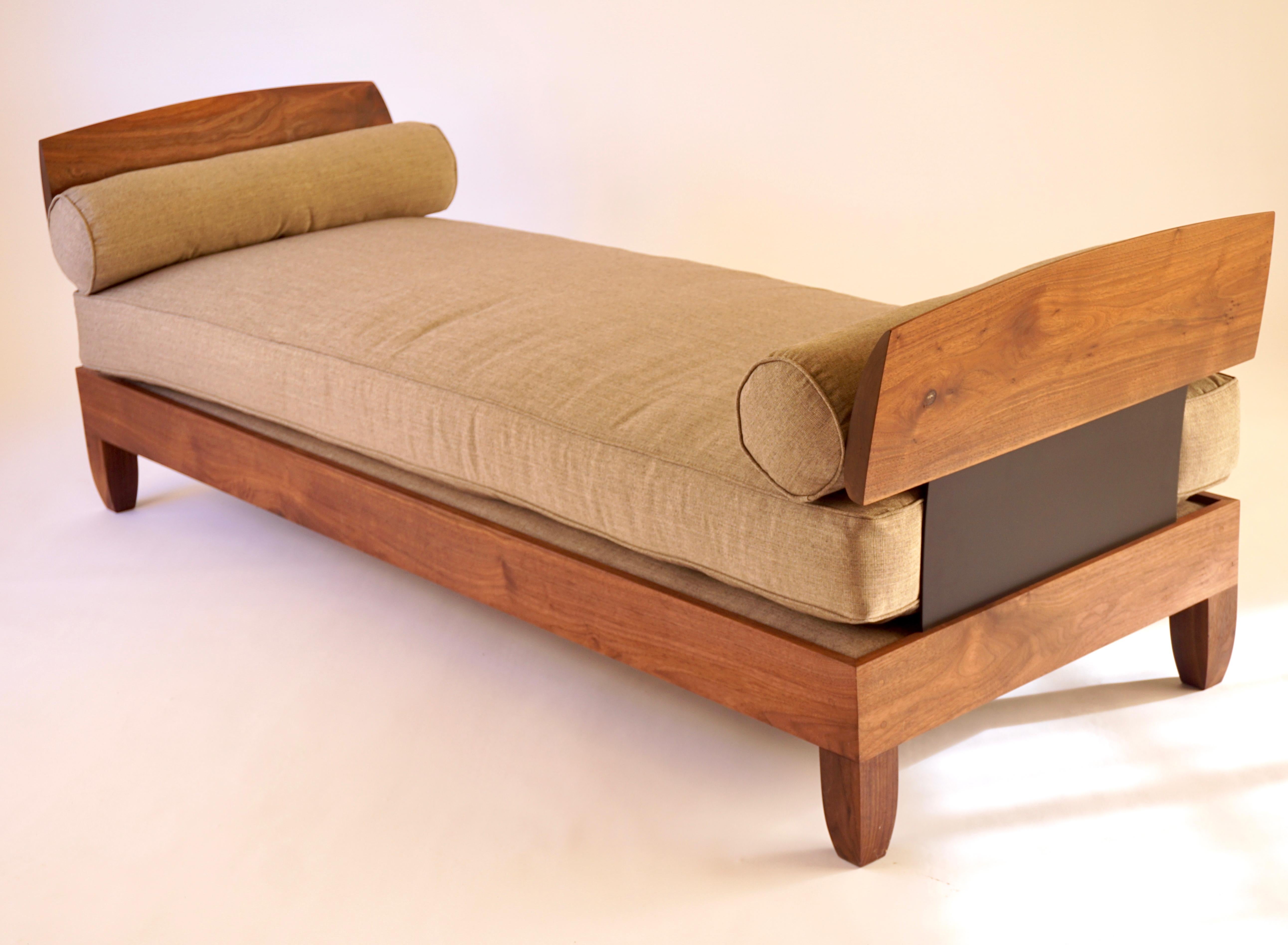 The classic Lehrecke daybed was designed in 1996 at a time when the influences were a combination of Scandinavian and African, resulting in a primitive, yet highly refined, look. This version is made from black walnut with blackened aluminum side