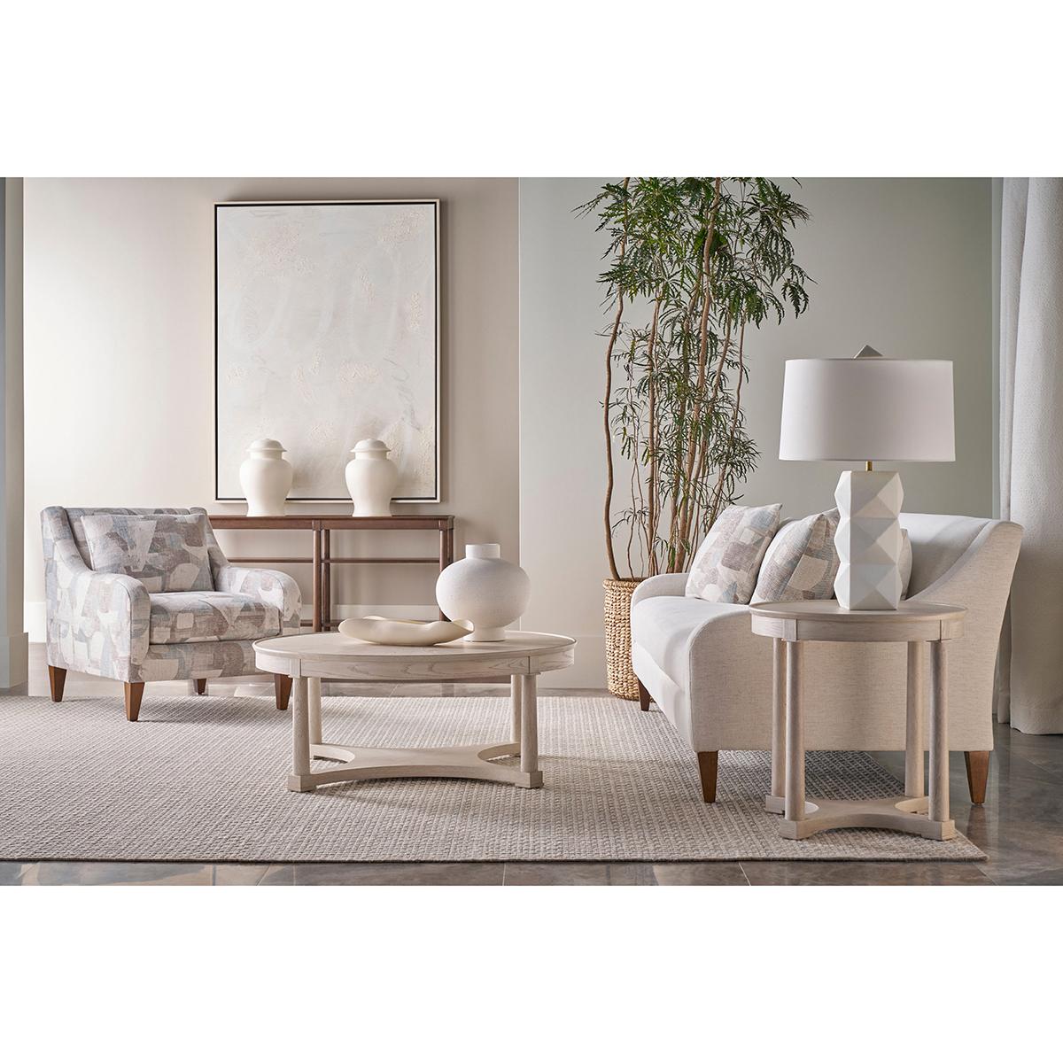 Crafted in oak and finished in our elegant white Dover finish, it features a gently recessed dishtop surface supported by six column legs with squared accents. Two open lower tiers provide generous storage and display space, ideal for entryways,