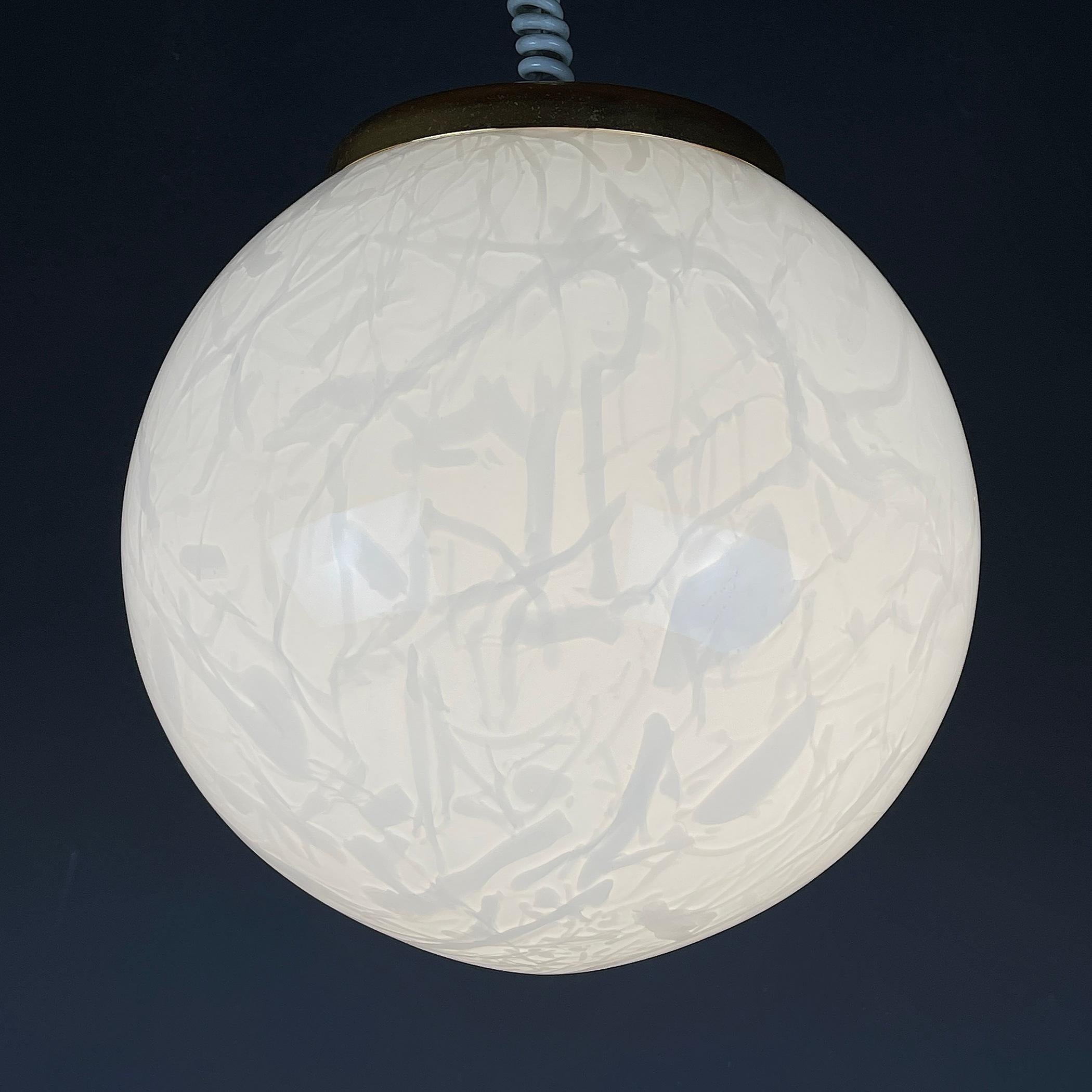 Elevate your space with timeless elegance through this stunning white Murano pendant lamp, handcrafted in the 1970s Italy. Its flawless condition exudes sophistication, showcasing the exquisite beauty of Murano glass.

Impeccable and fully