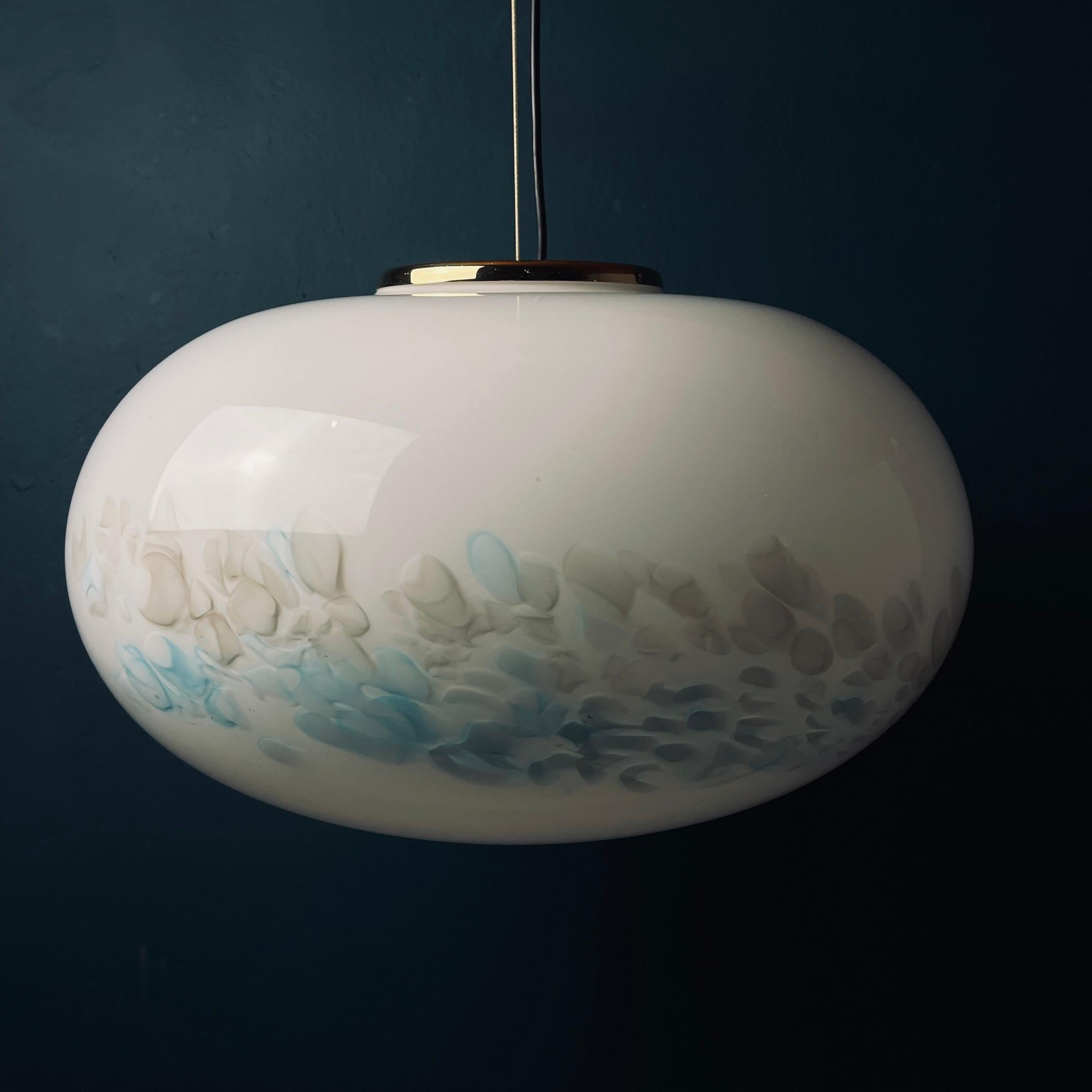 Classic white murano pendant lamp made in Italy in the 1980s. Very beautiful white Murano glass with blue spots in the form of a sphere. The lamp is in perfect condition, fully functional. No chips or cracks. Maximum height with cable 120 cm. The