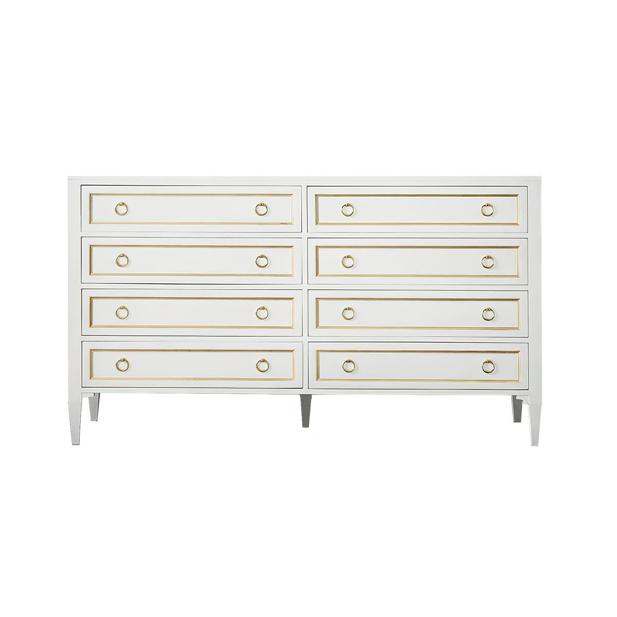 Classic White Painted Dresser with an antique white lacquered finish. This eight-drawer dresser complements both traditional and modern decor. 
With recessed panels having gilded trim, brass ring pulls, and raised on square tapered