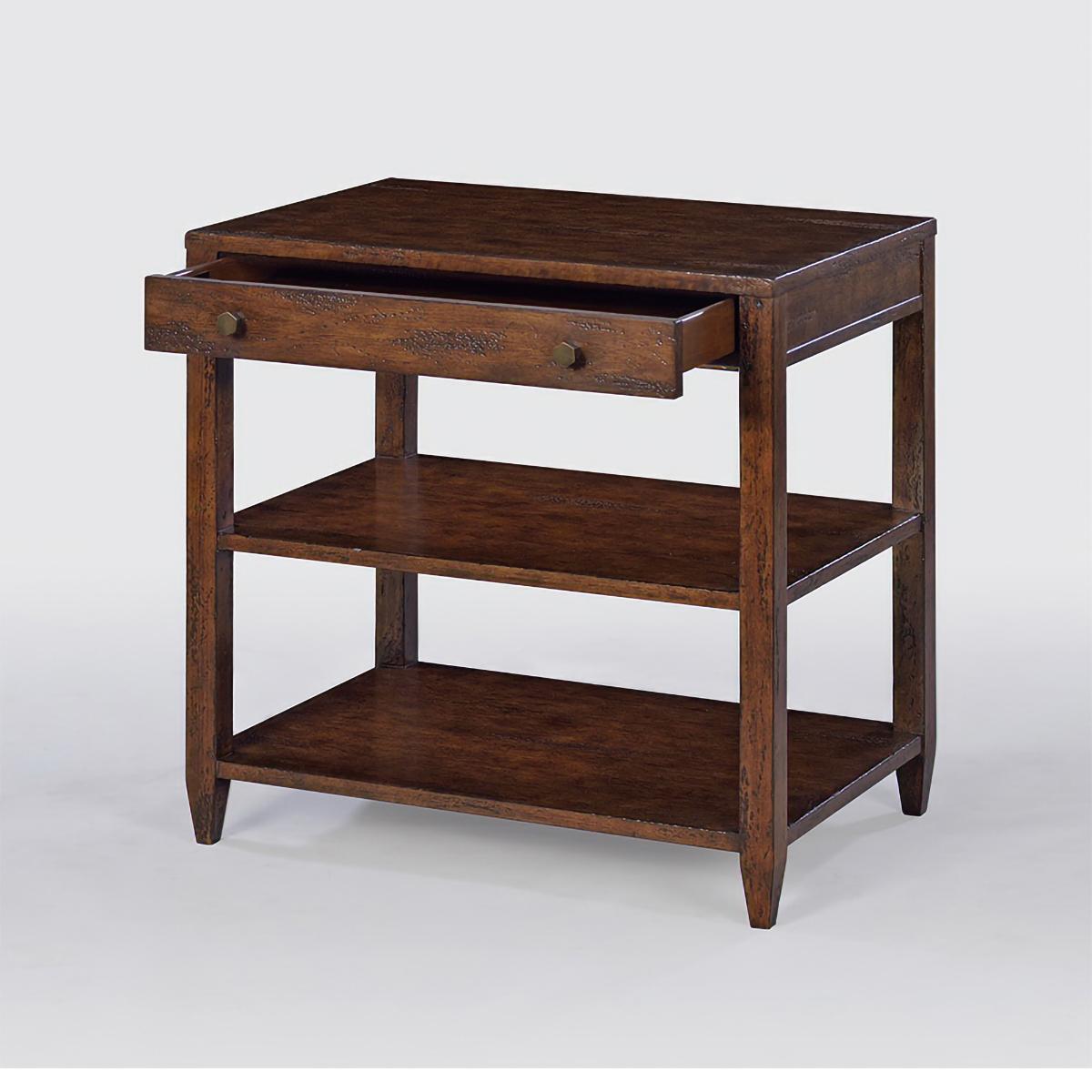 Classic wide rectangle side table with a drawer, two shelves, brass hardware, and tapered feet, has a “country” mahogany wood tone with natural highlights.

Dimensions: 26