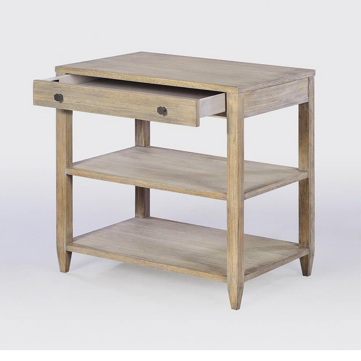 Classic wide rectangle side table with a drawer, two shelves, brass hardware, and tapered feet, has a “rabbit” finish showing slight grain accents in celtis veneer and solids. 

Dimensions: 26