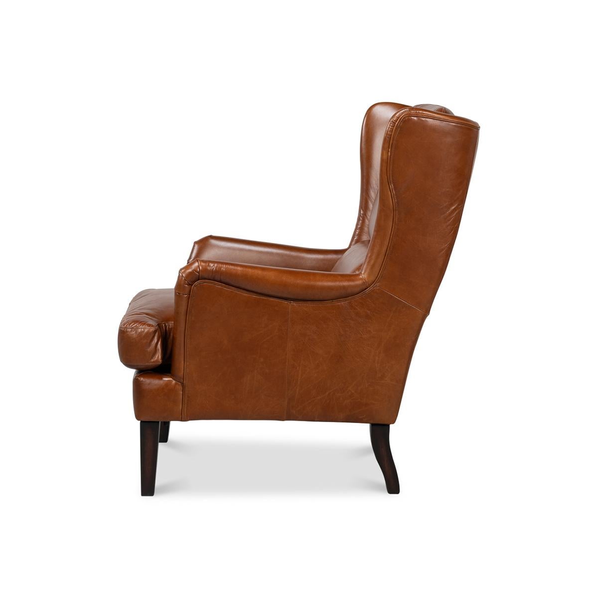 Aus braunem, traditionell genarbtem Vintage-Havanna-Leder, mit hoher, klassischer Flügelrückenlehne und kastenförmigem Sitzkissen auf konischen Beinen.

Abmessungen: 28