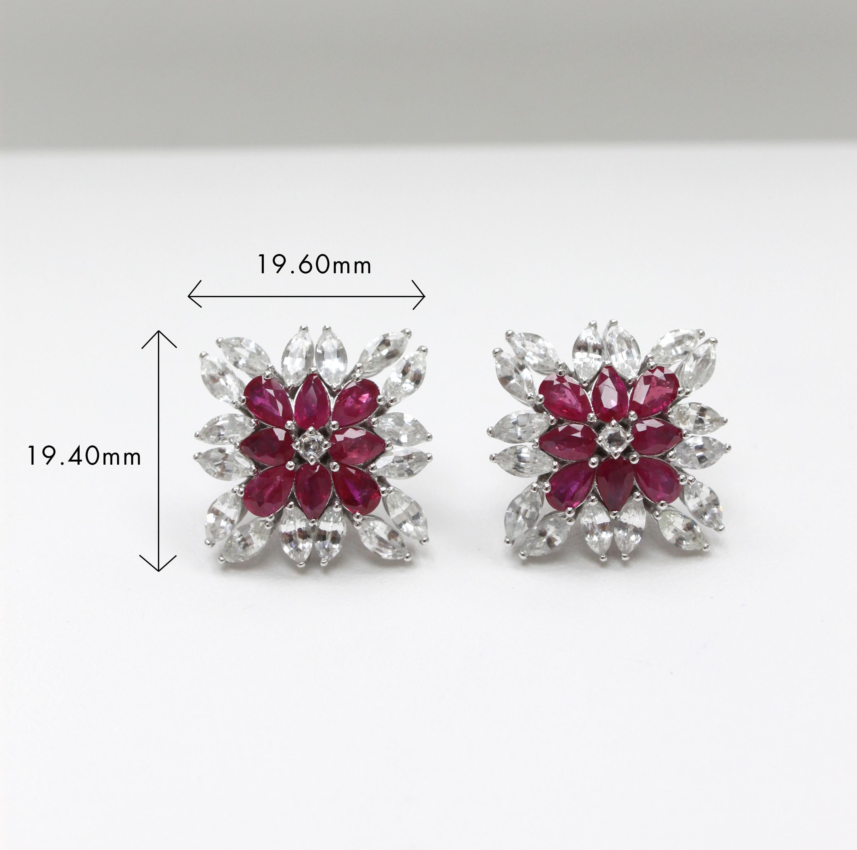 14K white gold
3.45ct ruby 
5.95ct white sapphire 
Total earring weight 10.41g

Mesmerizing geometry meets captivating color in these stunning 14K white gold earrings. At the center, a sparkling round white sapphire adds a touch of subtle