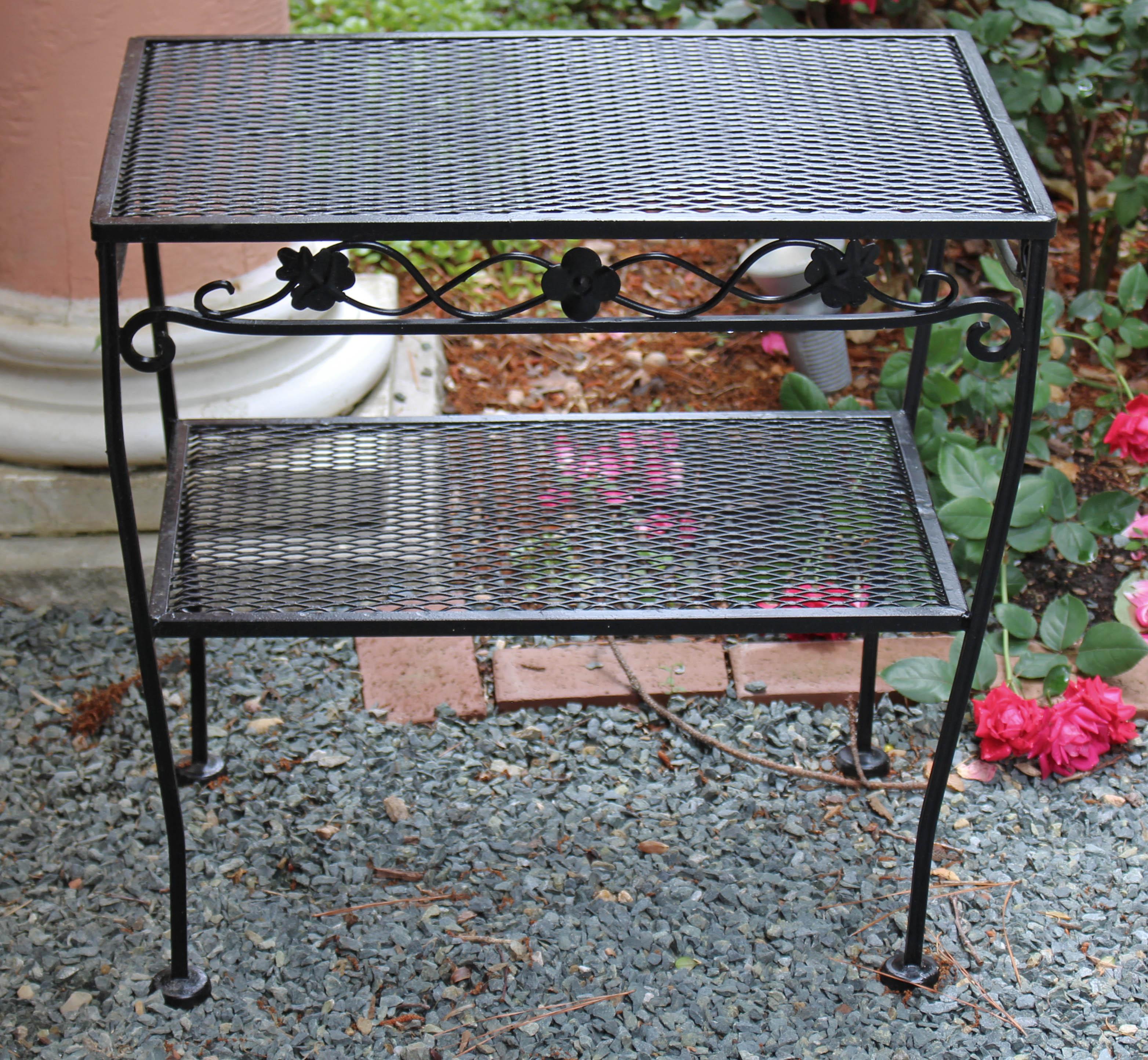 Classic Woodard wrought iron, 2-tier side table. Acquired c.1960 from Style Craft of Chapel Hill. Tendril motif apron surround. Shaped legs. 16