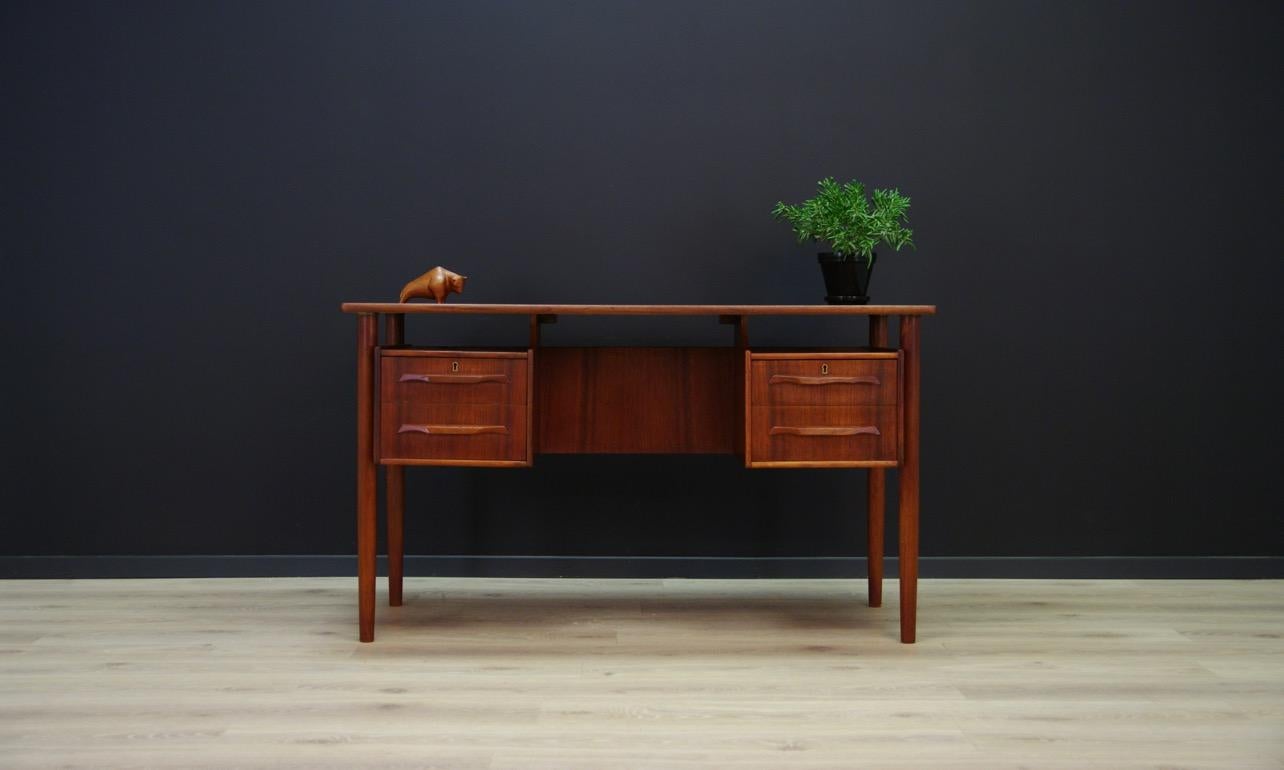 Writing desk from the 1960s-1970s, Minimalistic Danish design, perfect in every detail. Desk veneered with teak, turned legs, original handles. It has four drawers and a bookshelf at the back. Item does not have a key. Preserved in good condition