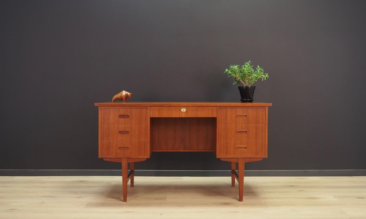 Stylish desk from the 1960s-1970s, Danish design. Classic Danish minimalism. Finished with teak wood veneer. Fantastic front with seven drawers. Bookshelves at the back. The key in the set. Preserved in good condition (small bruises and scratches) -