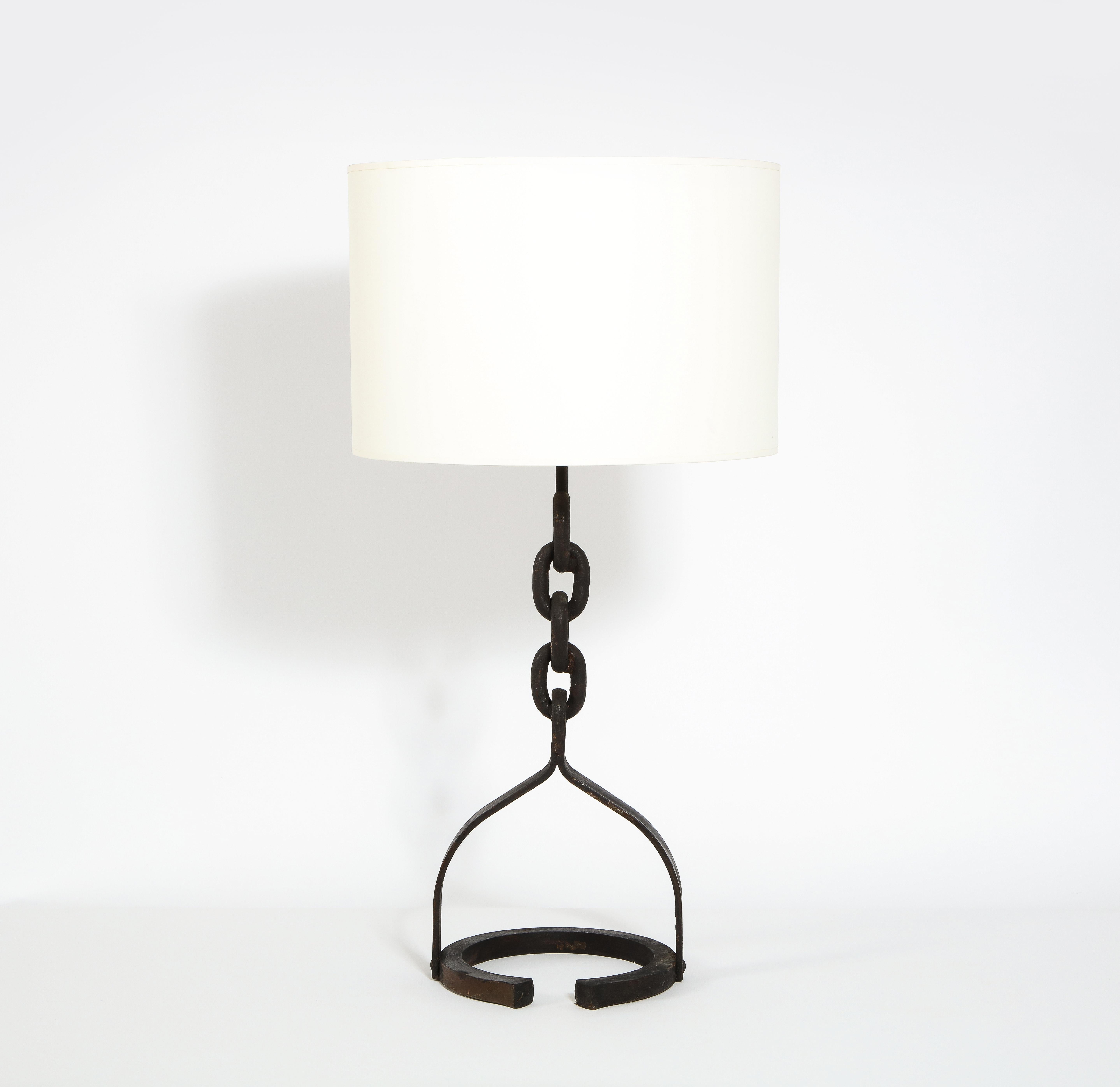 A wrought iron table lamp made of welded chain links on a half-round base. Shade not included.

Also available, floor lamp version of same.