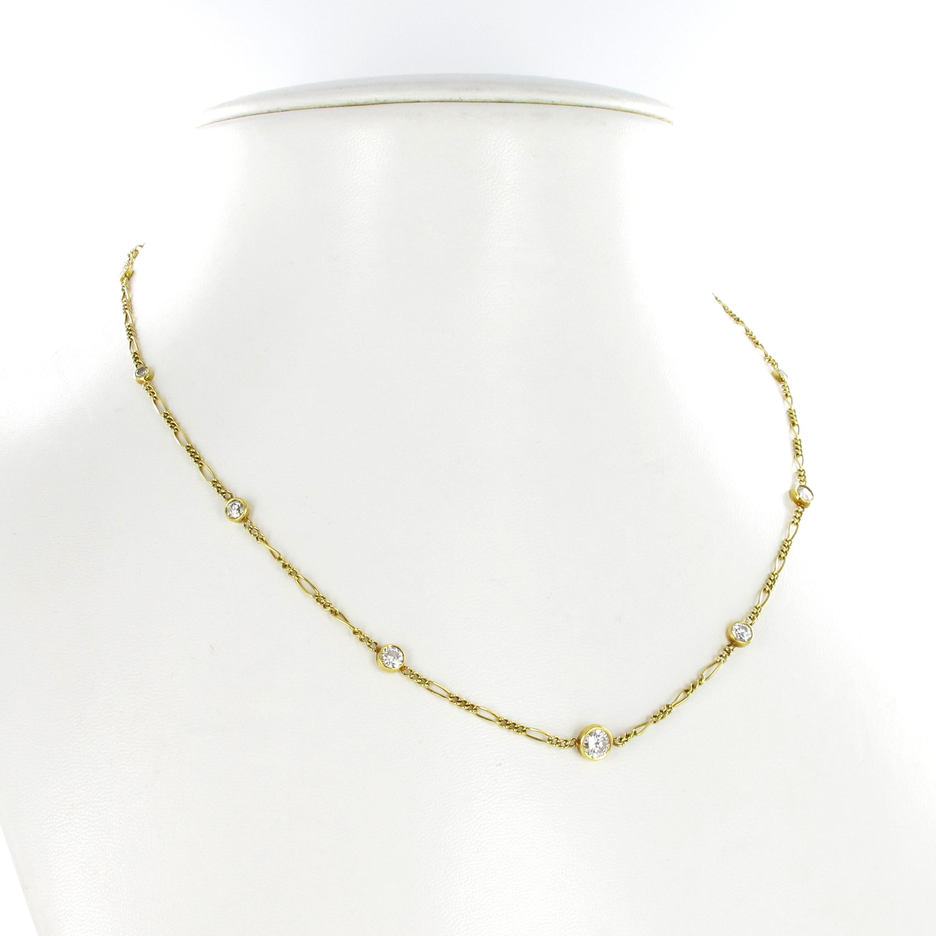 Delicate diamond necklace crafted in yellow gold 14K. Modified curb chain interrupted by 9 brilliant-cut diamonds totalling 1.14 ct of G/H-si quality. The bezel set diamonds range from 0.05 ct to 0.39 ct in individual weights. Chain secured with a