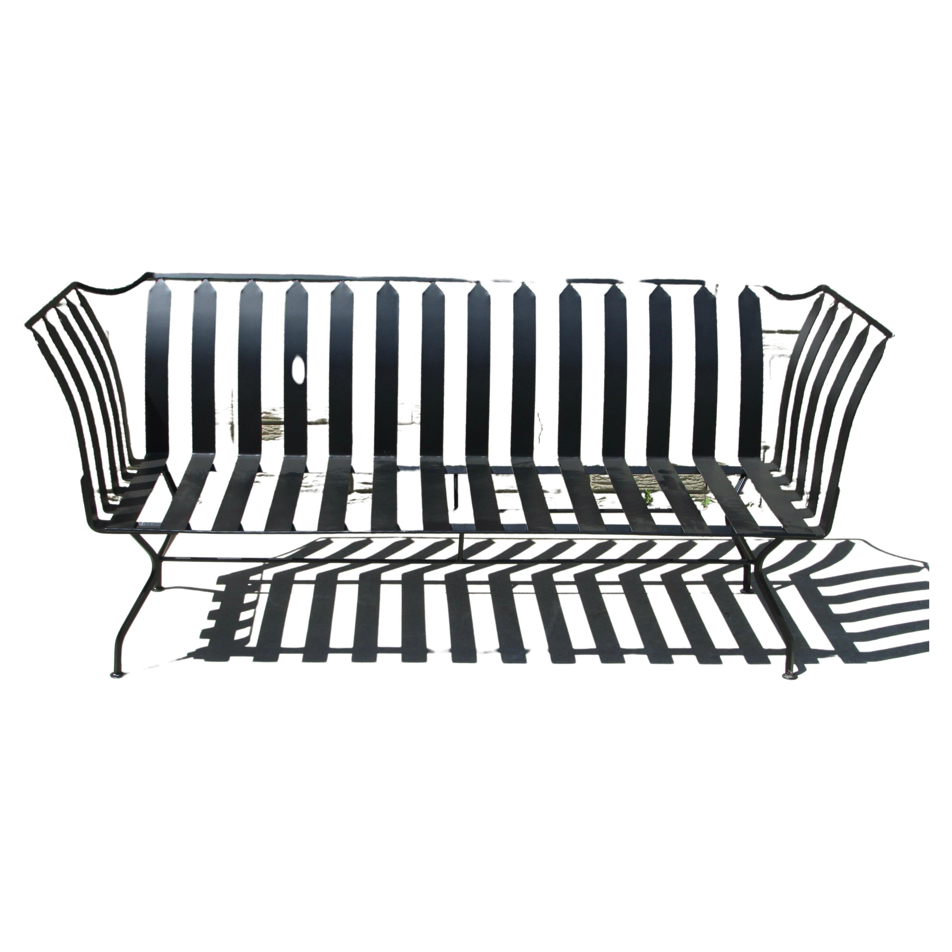 Classically styled modernist settee. Square stock wrought iron frame with flat band steel cushion supports. Salterini as manufacturer is my best attribution guess. Just over 5 feet wide, seat height twelve inches without cushion as shown. Settee has