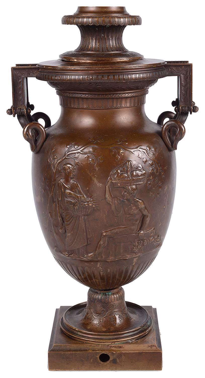 A good quality late 19th century bronze lamp in the Greco-Roman style, having classical figures in the gardens and swan neck handles.