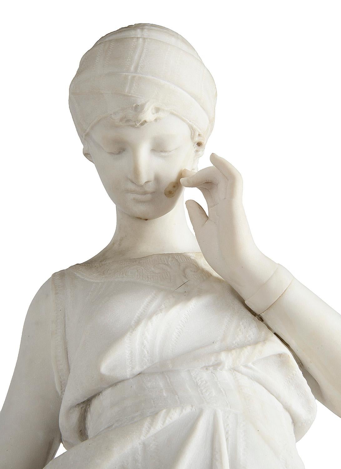 A good quality late 19th century Italian Carrera marble statue of a young maiden with a water jug resting on a wall.