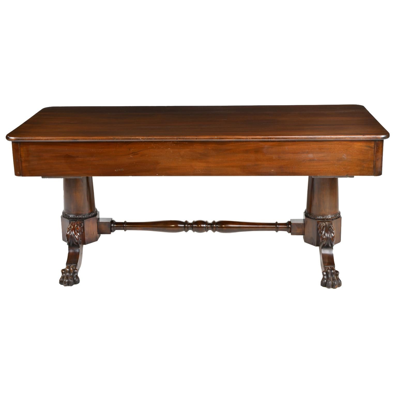 A very handsome and functional classical American bureau desk in dark Cuban mahogany, likely from Philadelphia. Offers three drawers along the apron, one longer center drawer flanked by a drawer on each side, all with convex fronts and original