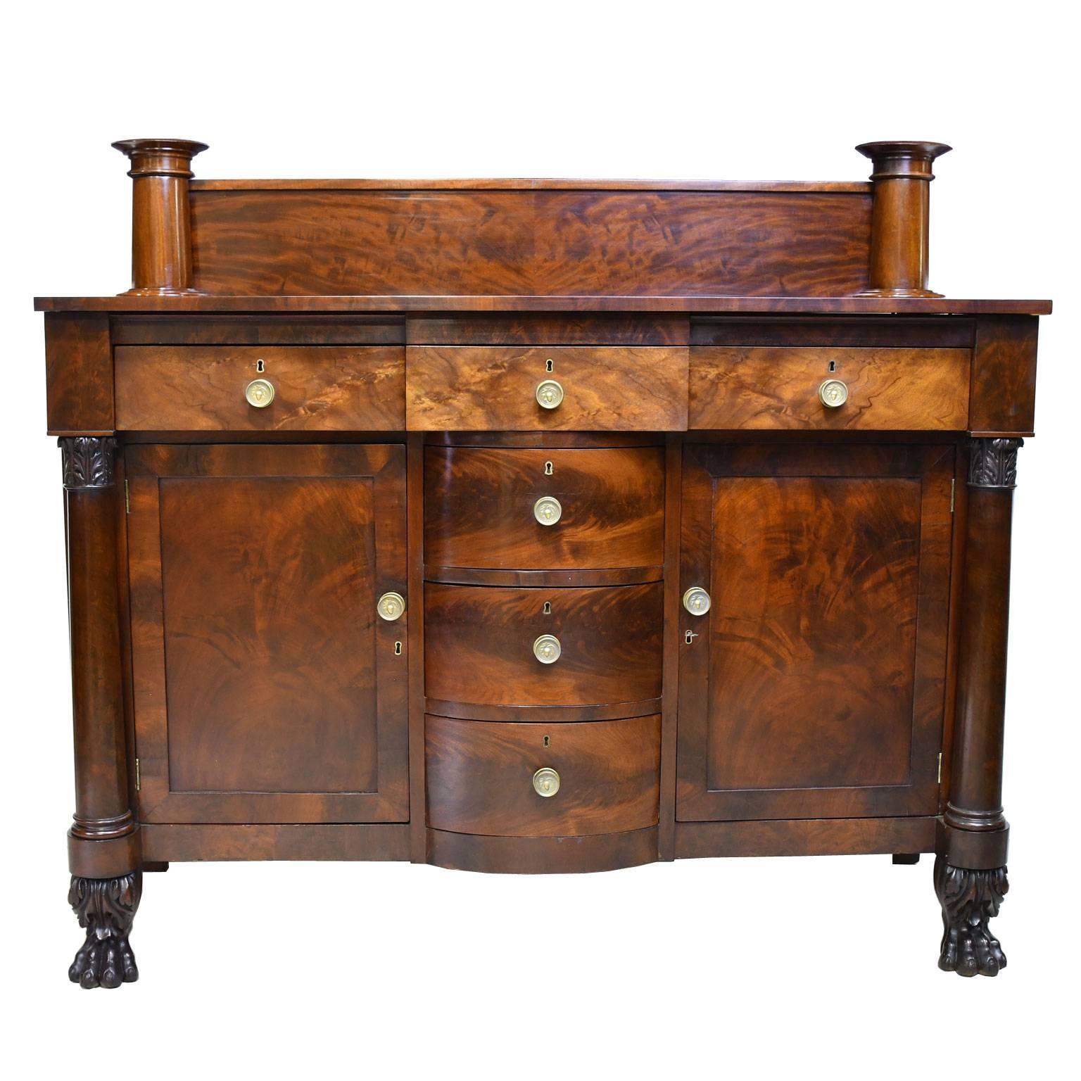 A beautifully-proportioned American Empire sideboard in a superb selection of crotch-cut and flat cut Cuban mahogany veneers. Drawer sides and bottoms are in poplar and the secondary wood is northern white pine. Flight of three drawers in the center