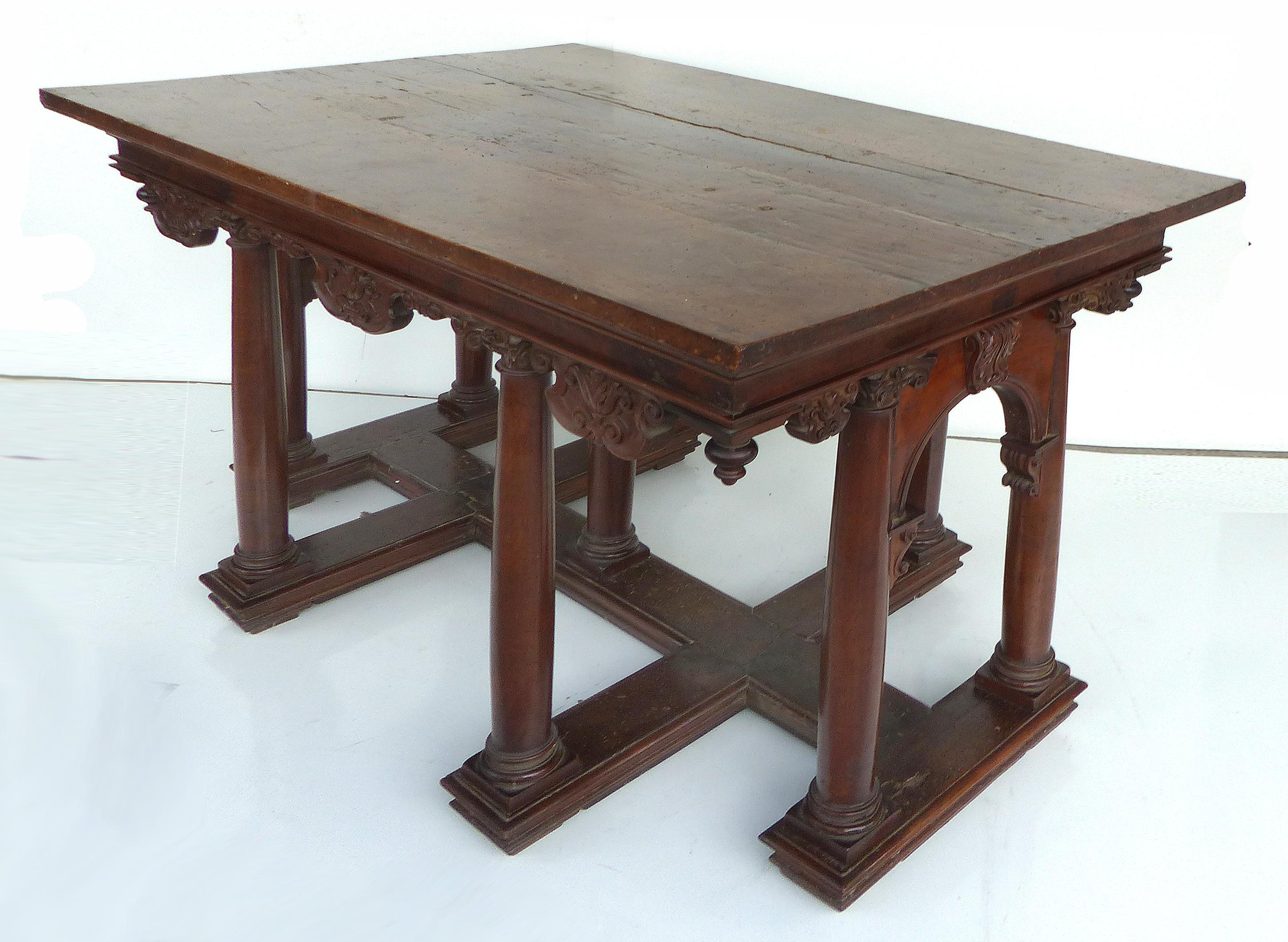 Classic antique library center table with Ionic columns

Offered for sale is a substantial antique library table supported by nine legs in the form of columns with classical Ionic Capitals. The table is carved with acanthus leaves and has crossed