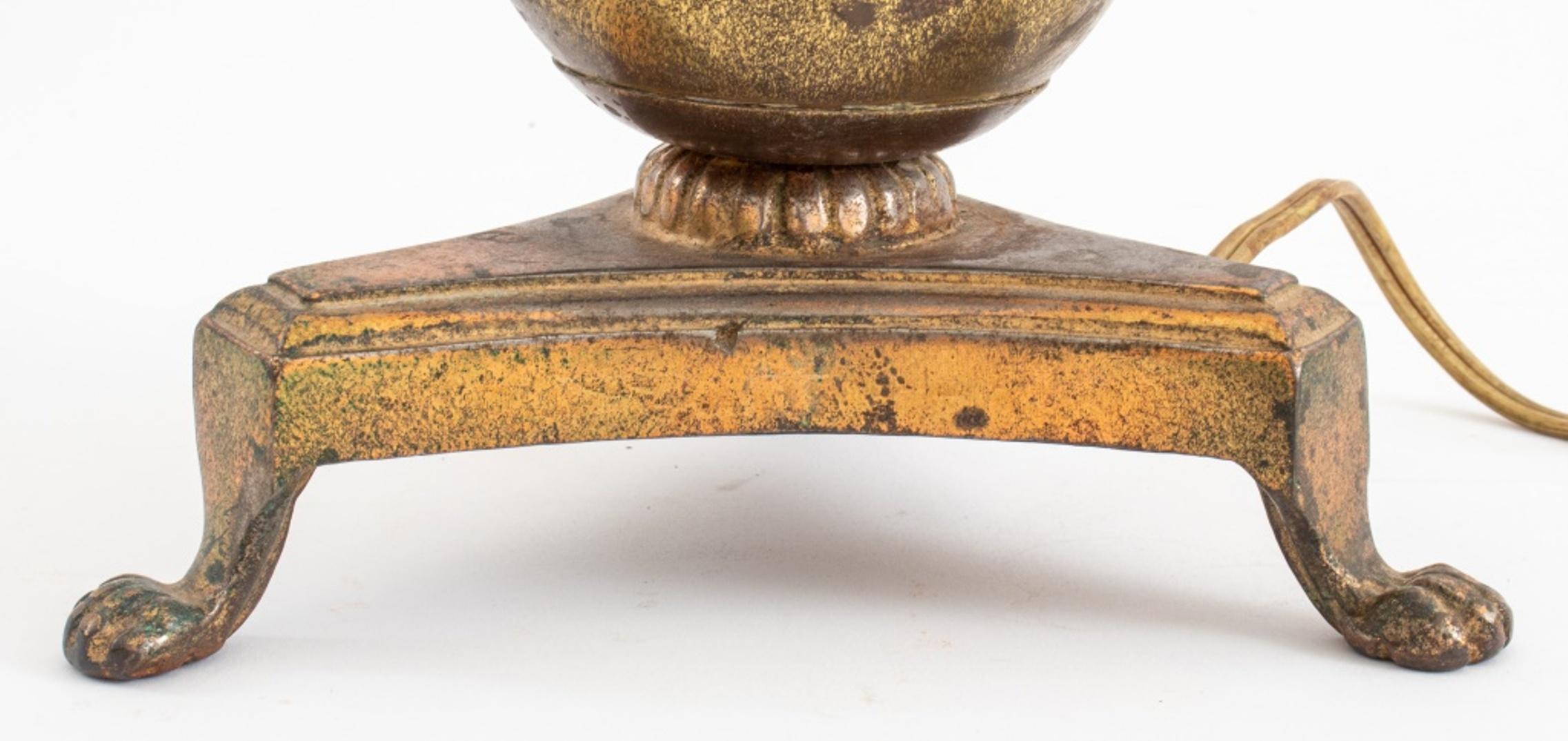 Classical ball and arrow table lamp, copper-toned brass, on a base with four claw feet, with an American plug.

Dimensions: 19