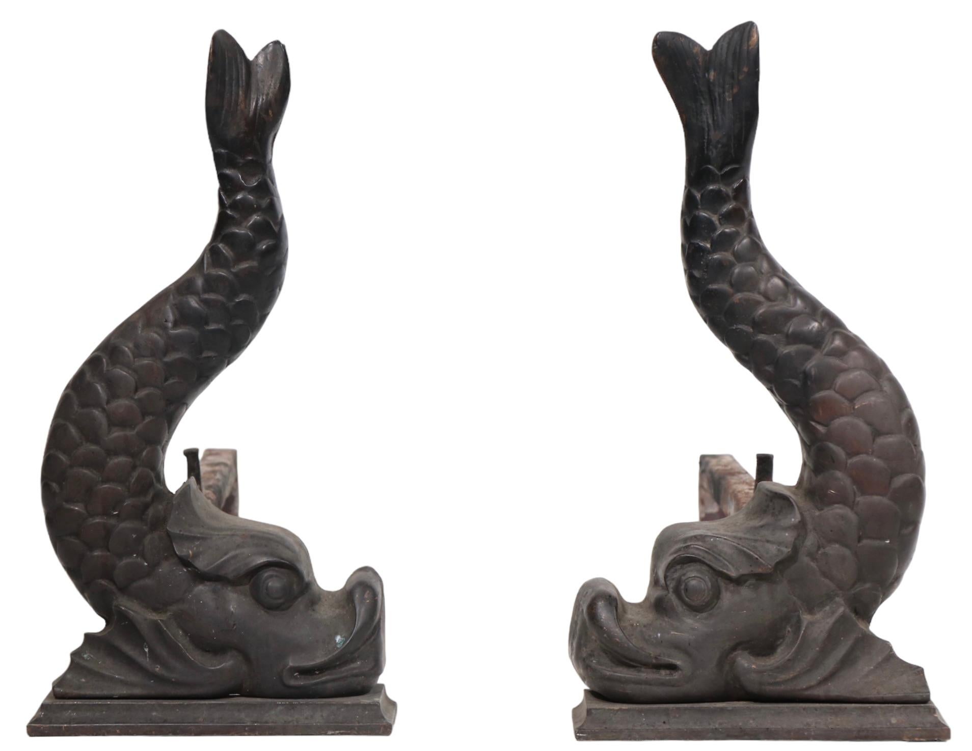 Solid cast bronze fantasy fish form andirons. Nice original dark  patina.