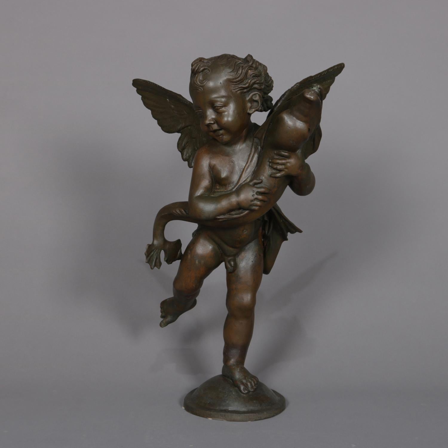 A classical and figural bronzed metal sculpture fountain head features young Neptune as winged cherub with fish, 20th century

Measures: 29