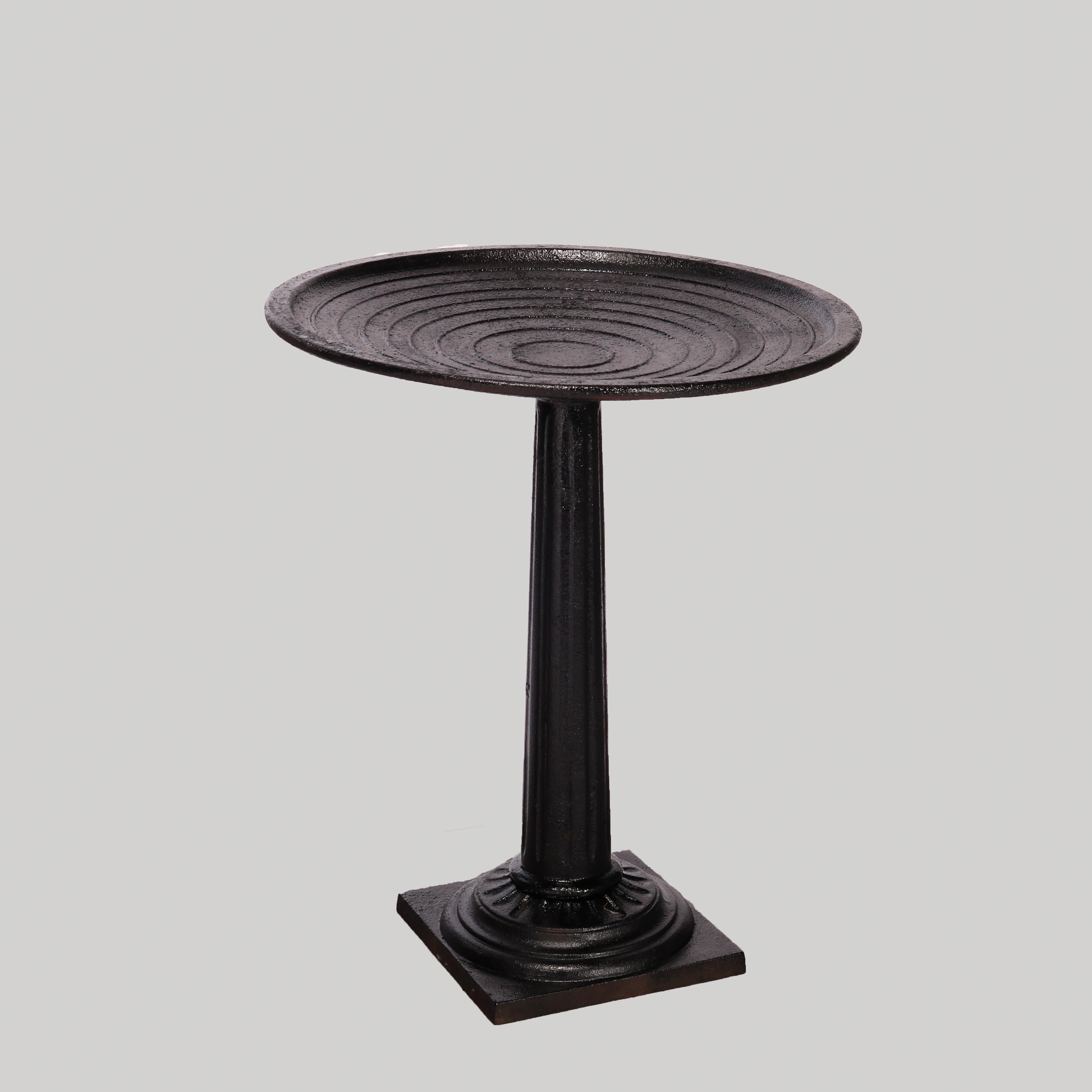 A Classical garden birdbath offers cast iron construction with bathing bowl seated on reeded and flared Greek column pedestal, 20th century

Measures- 27''H x 22.75''W x 22.75''D.

Catalogue Note: Ask about DISCOUNTED DELIVERY RATES available to