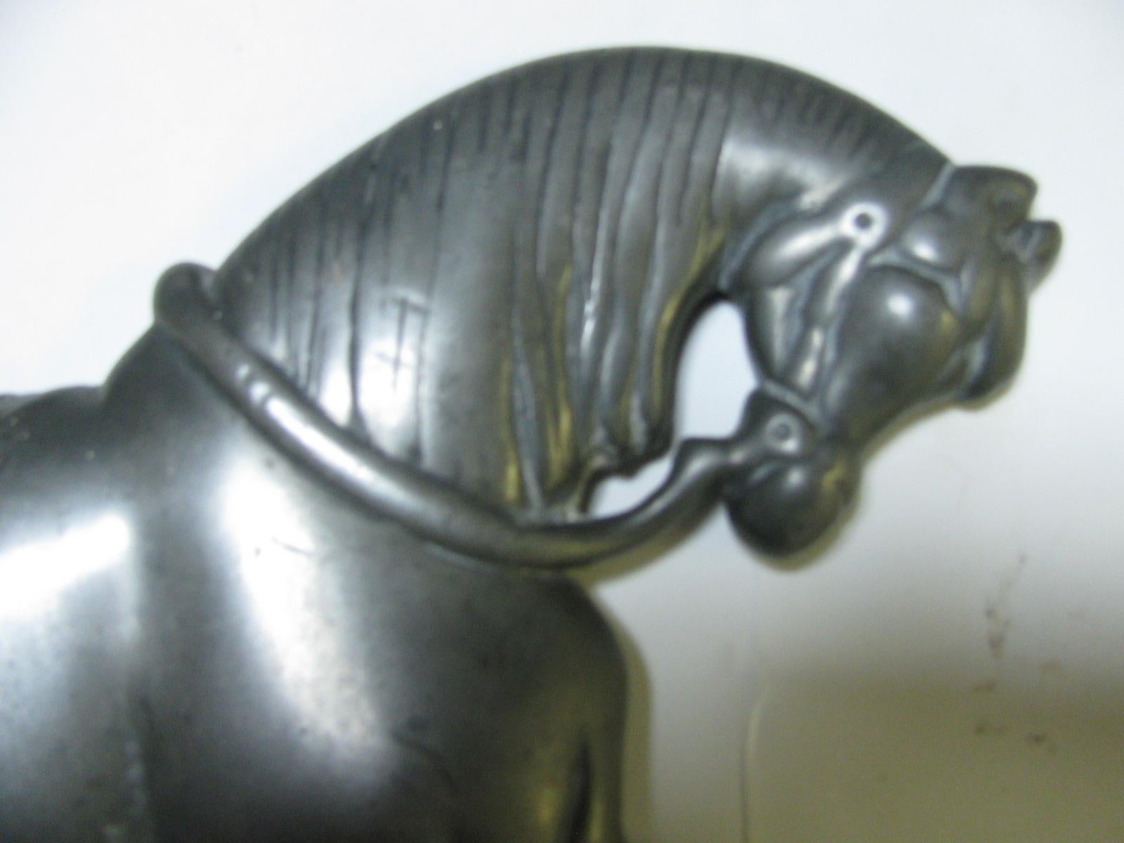 Beautiful rendition of a prancing horse in cast nickel over iron. Plinth base.