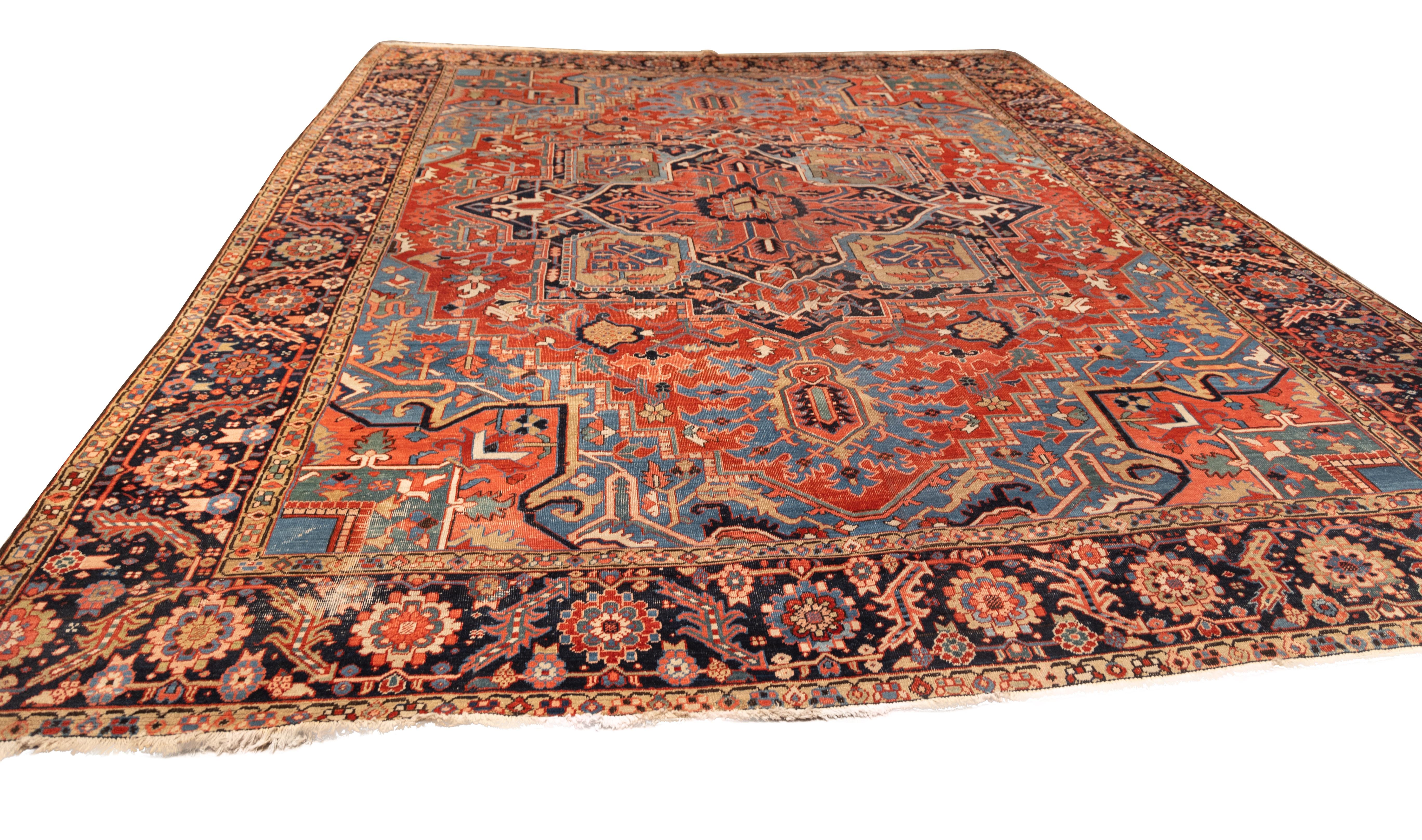 Stunning 20th-century Heriz rug With a medallion design in a saturated palette of brick red, midnight blue, and sky blue. The robust central medallion radiates geometric intricacy, flanked by  corner spandrels with angular, serrated leaf motifs and