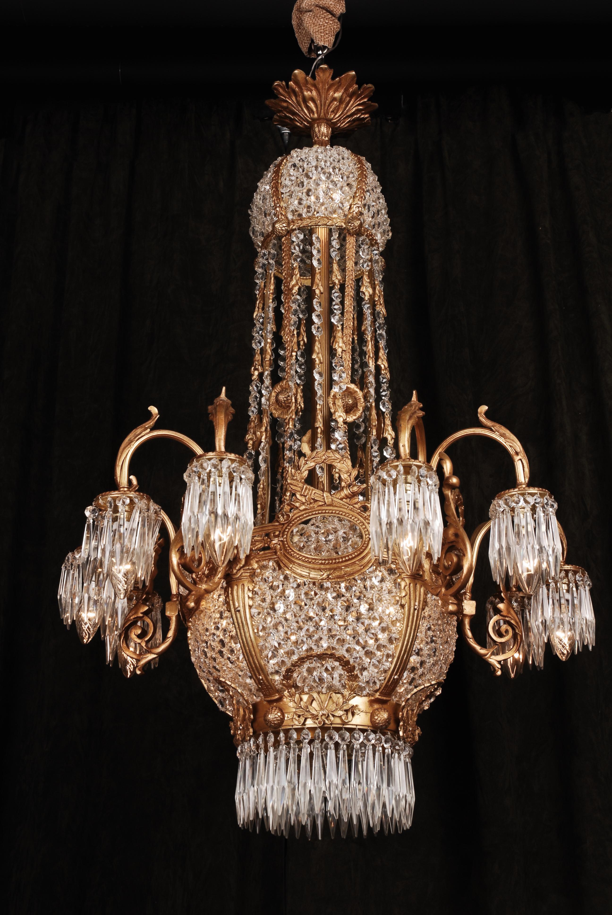 Classical chandelier in Classicist style
 Bronze. Baluster-formed, profile framed corpus. Eight curved light arms.
 Height: 103 cm, Diameter: 65 cm

 