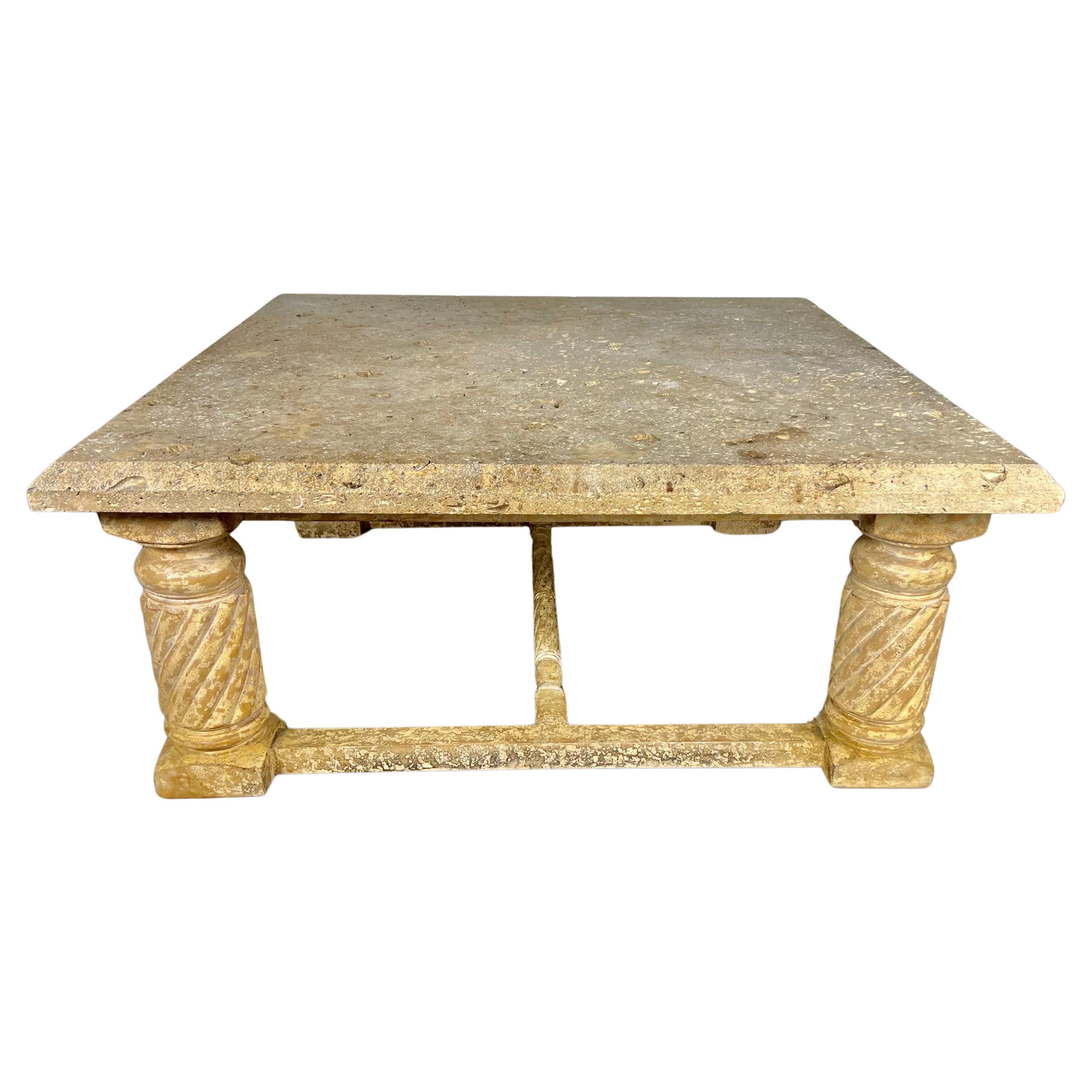 Late 20th century Italian Neoclassical style coffee table.  The table stands on four twisted wood straight legs.  The wood base has a beautiful crackled finish.  The limestone top has indentations of shells throughout.  It is a beautiful large scale