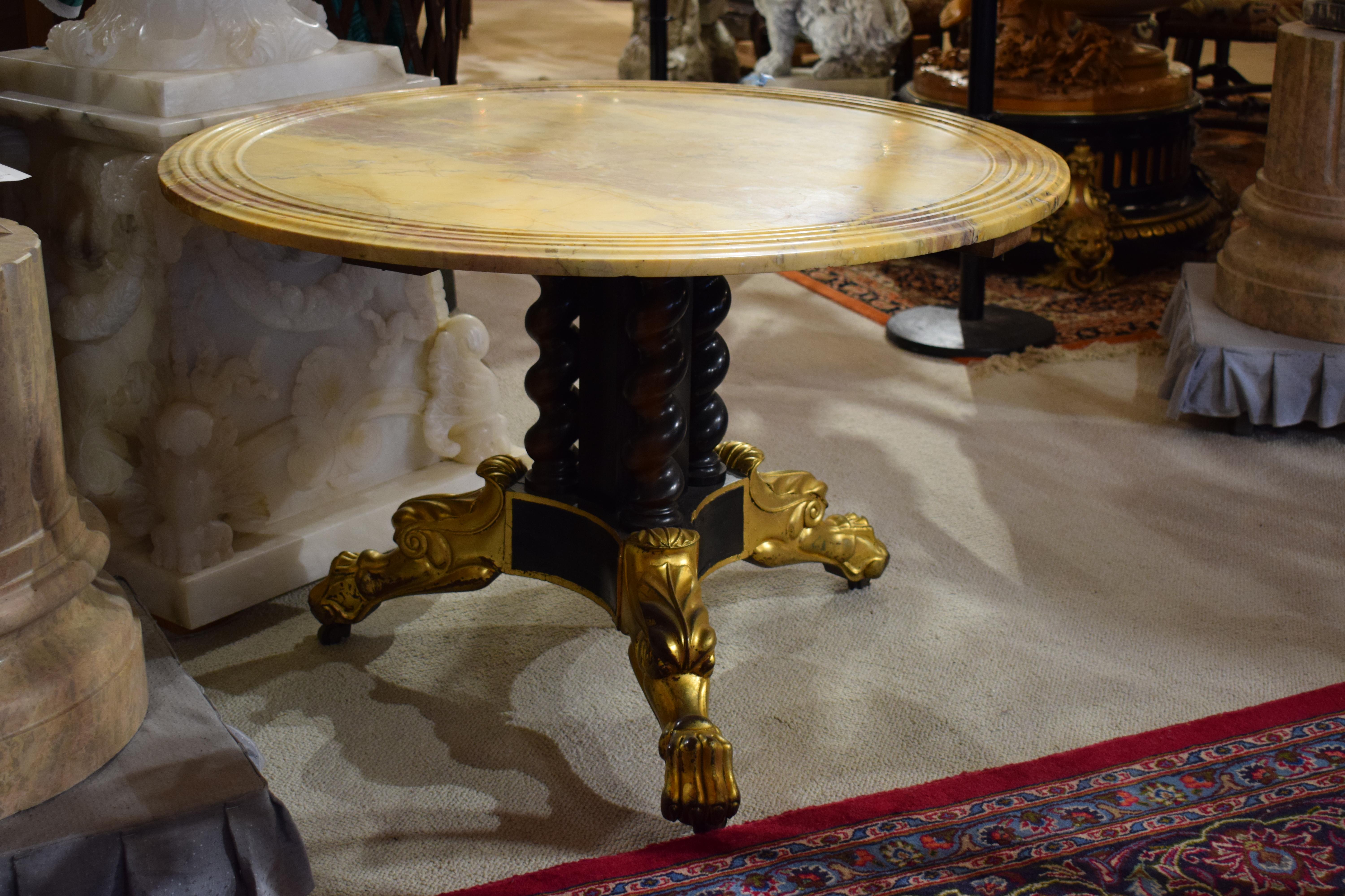 American and European, 19th century and later. Classical parcel ebonized and gilt table, having a circular Sienna marble top, on fluted pedestal with walnut twist supports, on triparte base with paw feet. Unmarked. 
Dimensions: Height 27