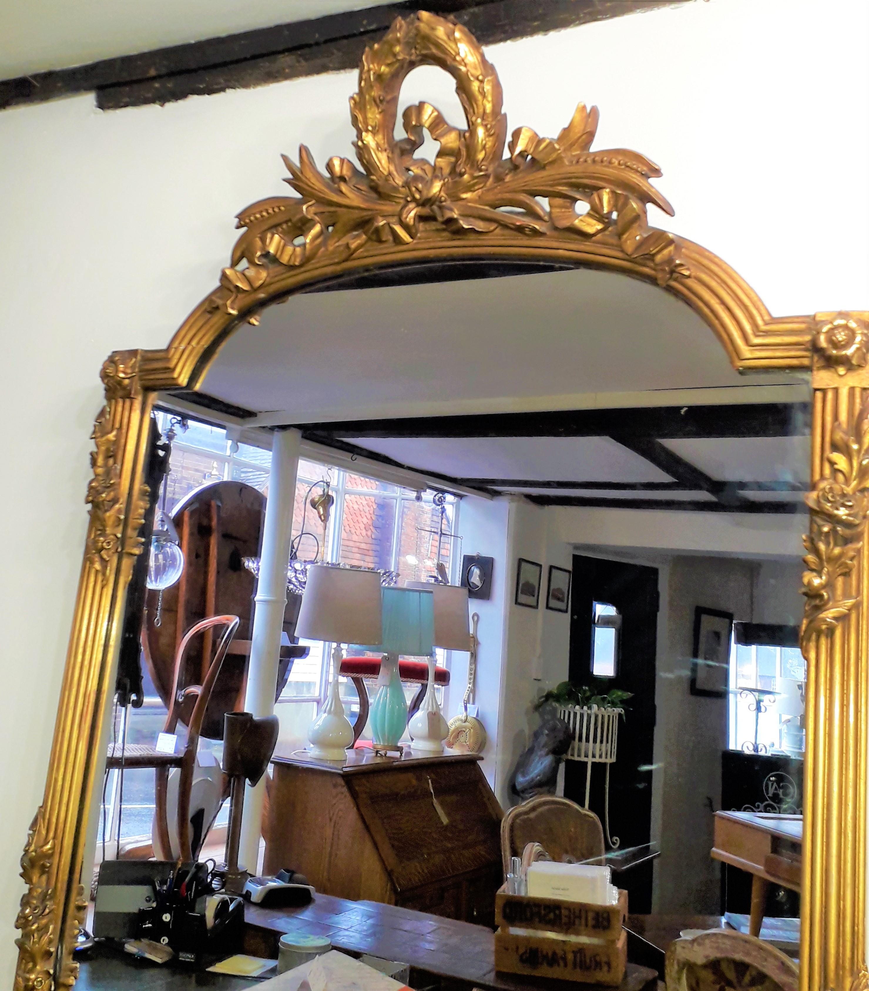 Superb quality 19th century Empire mirror, finely detailed ribbon and swag designs, the reeded borders set with floral applied motifs, it carries its original plate glass and its original weight.
  