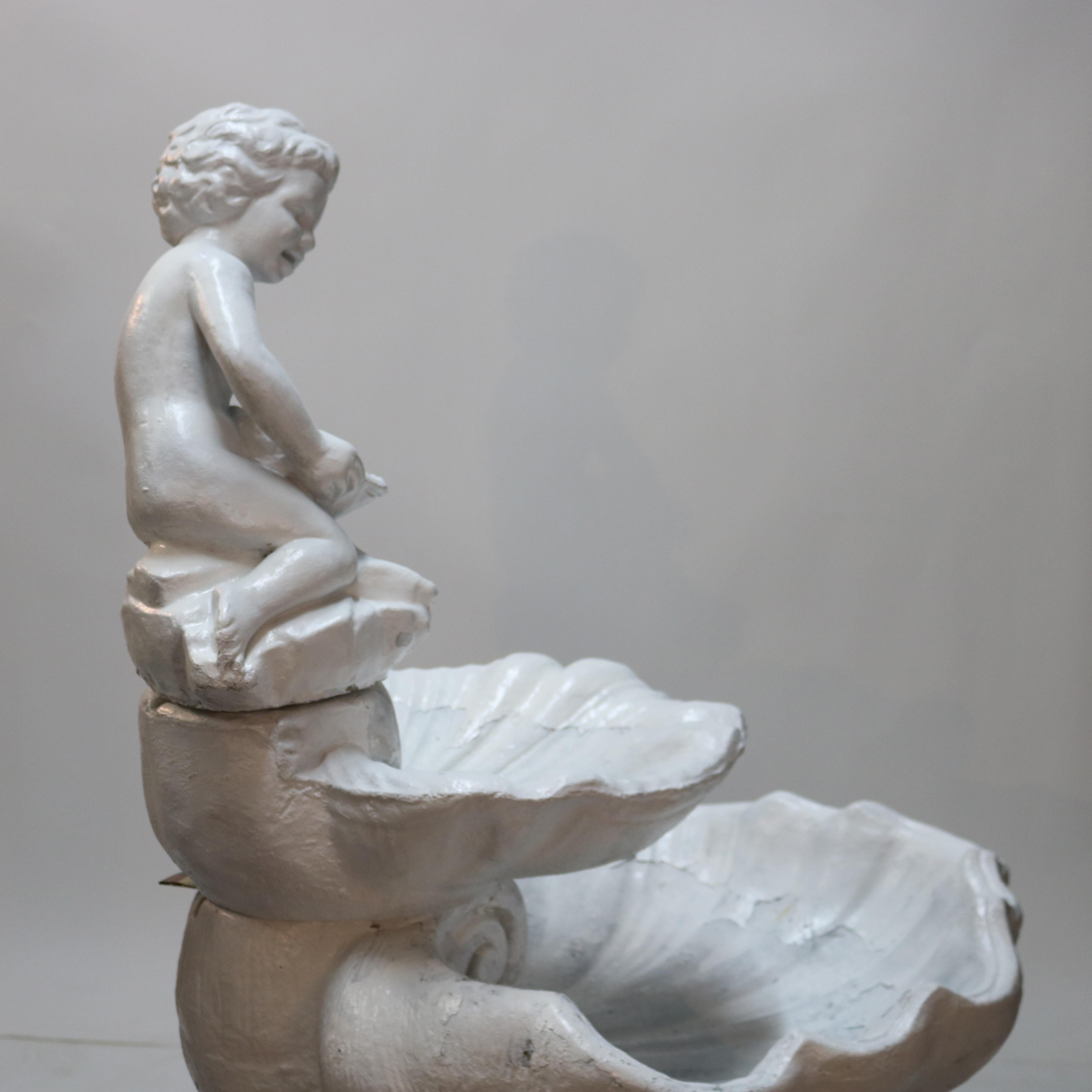 A Classical garden fountain offers painted cast stone construction with young boy over tiered fountain with tiered shell form bowls raised on reeded Doric columns, 20th century.

Measures- 54''H x 28.5''W x 30.75''D.

Catalogue Note: Ask about