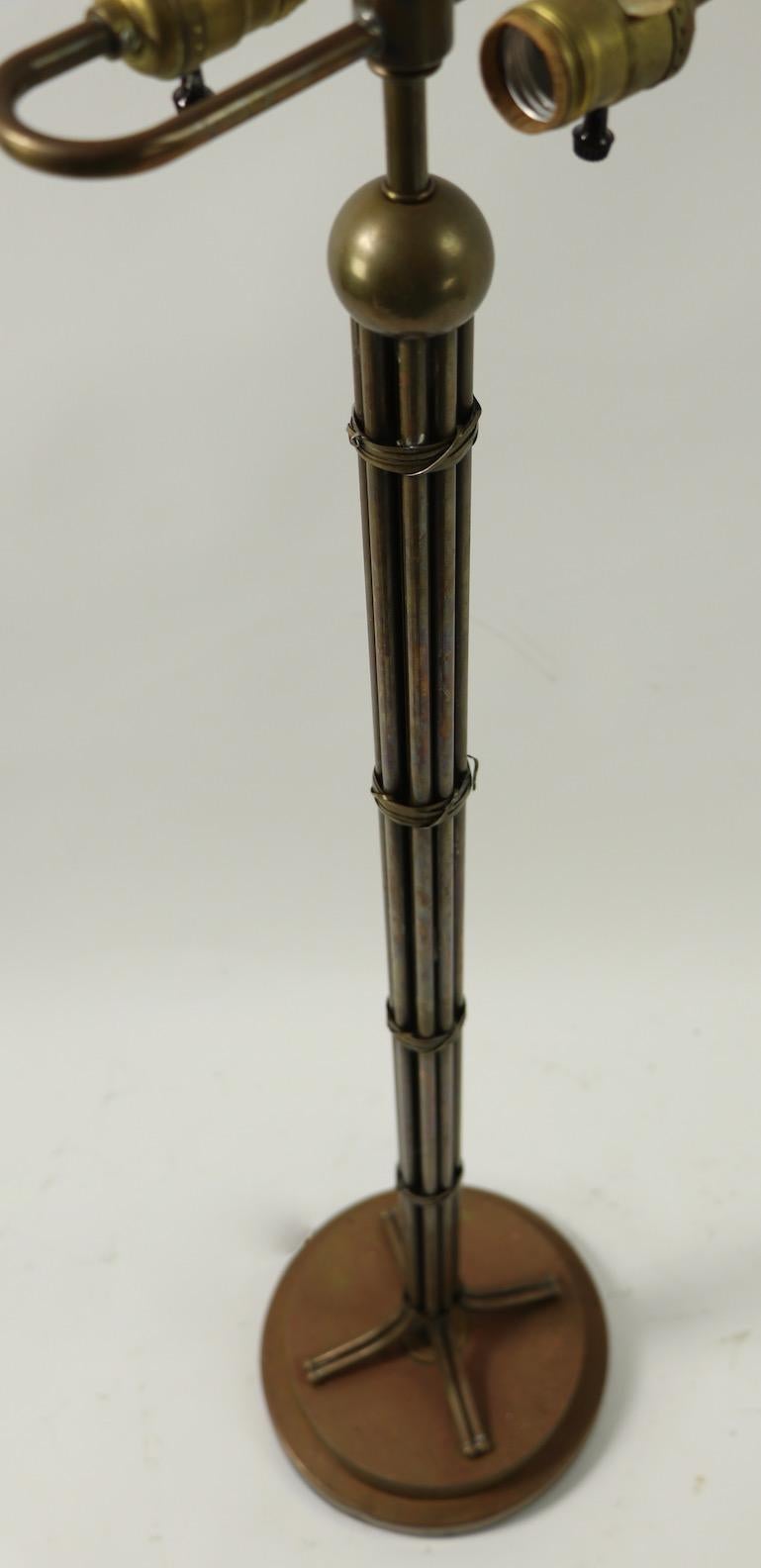 Classic gathered rod form brass, copper and bronze floor lamp signed Hart Associates. The lamp has two sockets at the top, each having its own individual on / off switch, each accepts standard size screw in bulbs. The lamp is in very good original