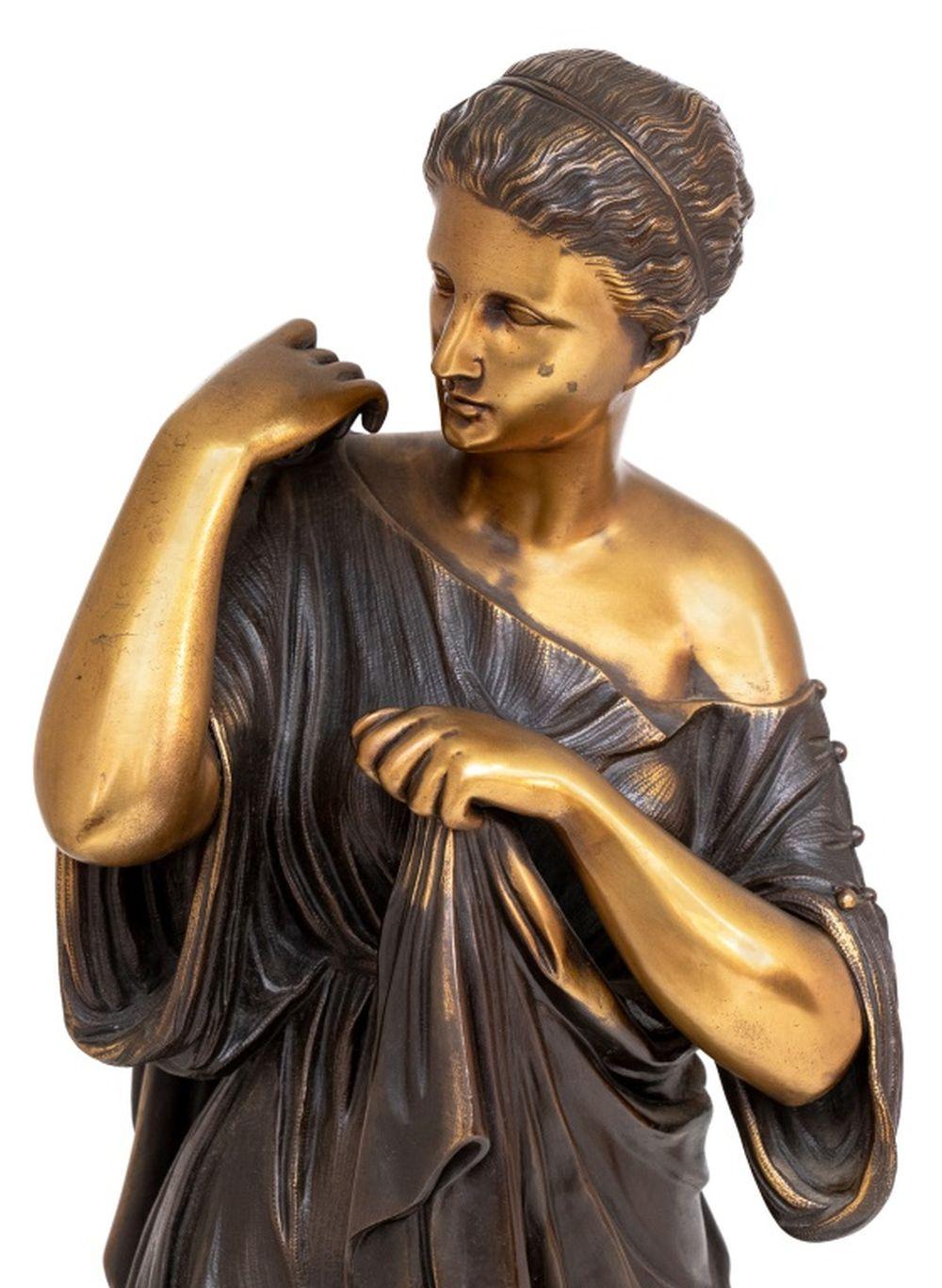 Classical Gilt and Patinated Bronze Sculpture of a Greek Woman, 20th century, the standing figure adjusting her dress, on a square plinth. 31.5