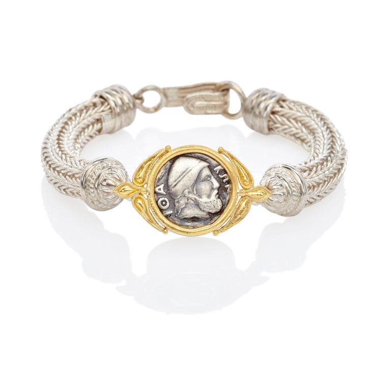 Classical Greek Bracelet with Odysseus Coin in Silver and 22 Carat Yellow Gold. When history meets fashion we have a unique result. This design portrays Odysseus, a universal symbol, so this is a 'Bracelet for him'
Coin front: - The head of