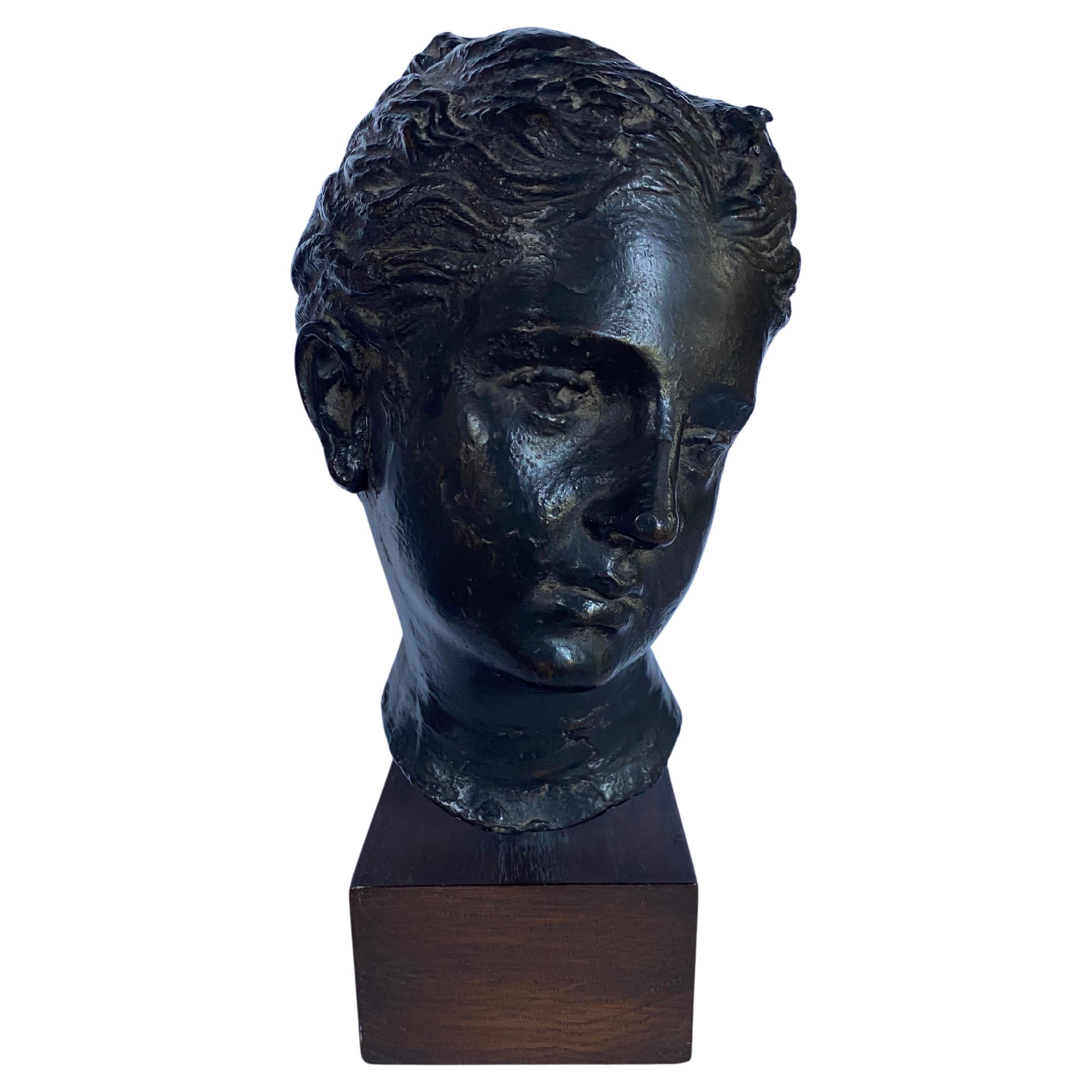 Classic Grecian style cast metal female goddess bust replica by Metropolitan Museum of Art, Circa 1982.  This weighted metal bust features a bronze tone finish and is mounted on a square plinth base.  Marked 