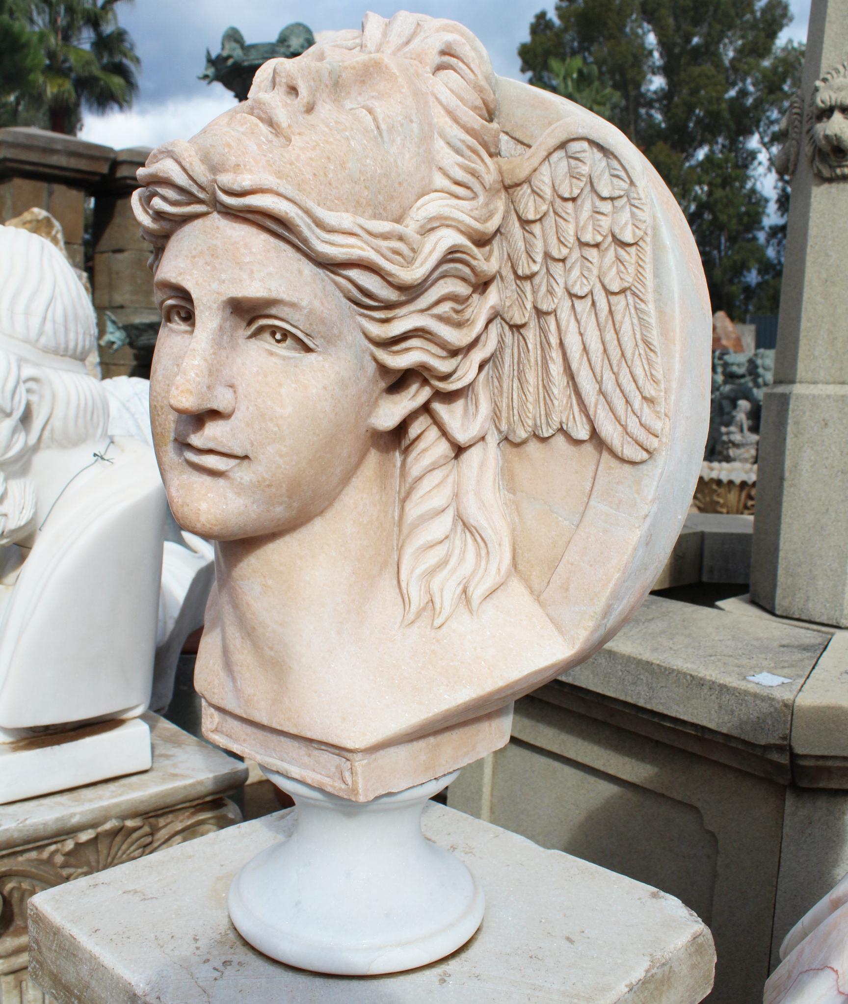 Classical hand carved Portuguese Rosa marble two faced winged bust on a white marble base.