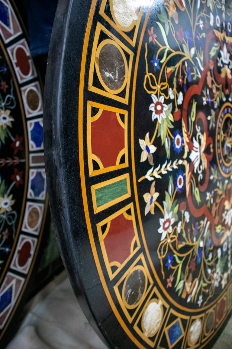 Classical Italian Pietra Dura stone black marble table top decorated with a bird surrounded by flower decoration and a geometric frame. Hand crafted mosaic inlay using blue lapis lazuli and an assortment of semiprecious stones and marbles. 