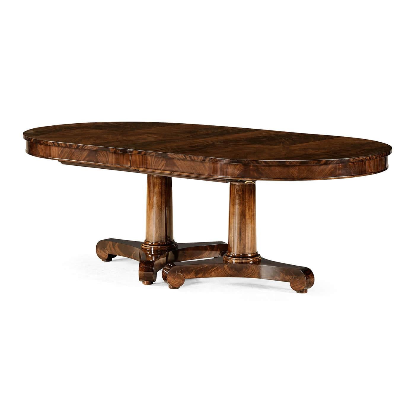 A 19th century-style Classical style d-end dining table fully veneered in fine crotch mahogany with two self-storing leaves. With bold column form twin pedestal bases set on elegant scrolling trefoil bases.

Open dimensions: 132
