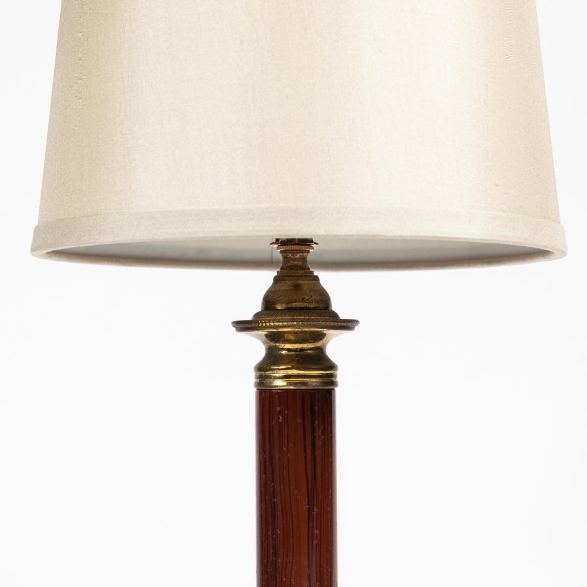 Neoclassical marble column and tole table lamp with lovely custom cream-colored linen shade. Tole is a painted, enameled, or lacquered tinplate used in decorative domestic objects, and in this case was used to create the illusion of wood. With its