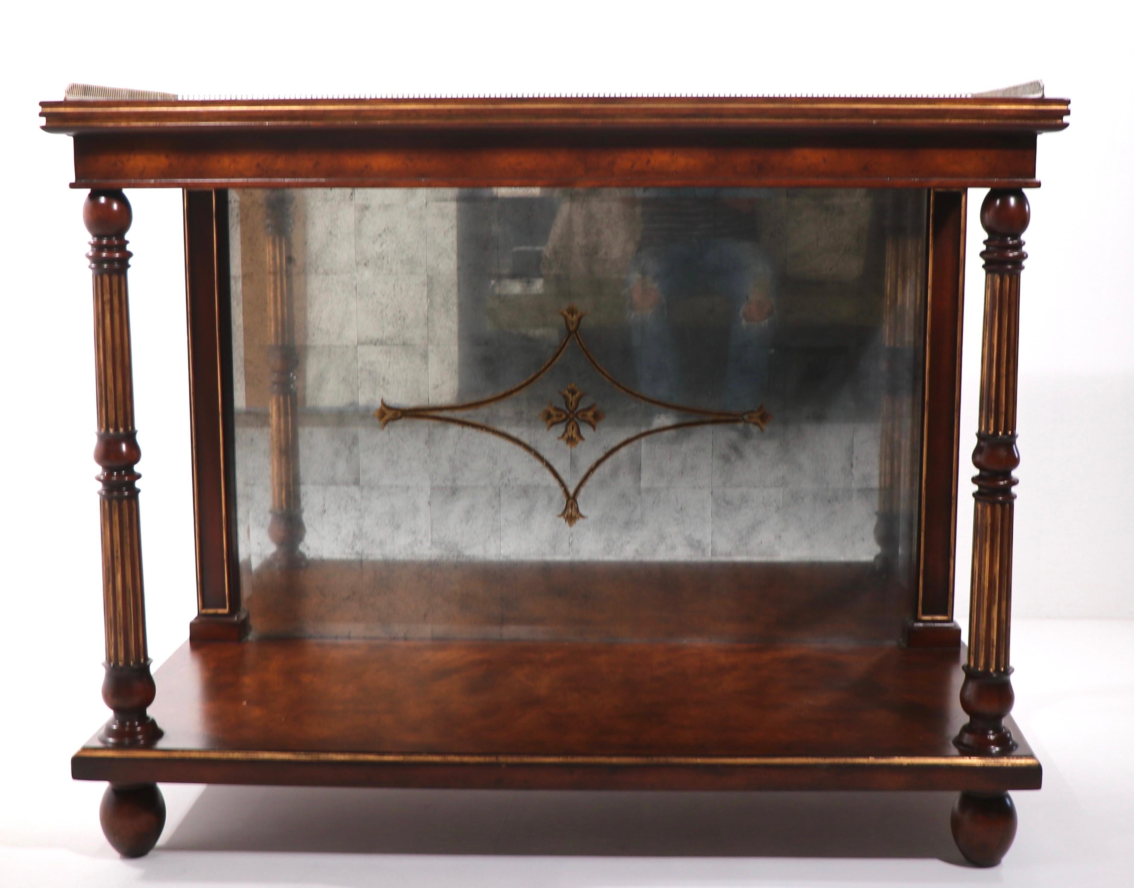 Stylish classical console sideboard by noted furniture maker John Richard from the European Crossroads series. The piece features a solid wood frame with brass gallery , and eglomise mirrored top and backsplash. 
 Total H inc. gallery 37 in x 36 in