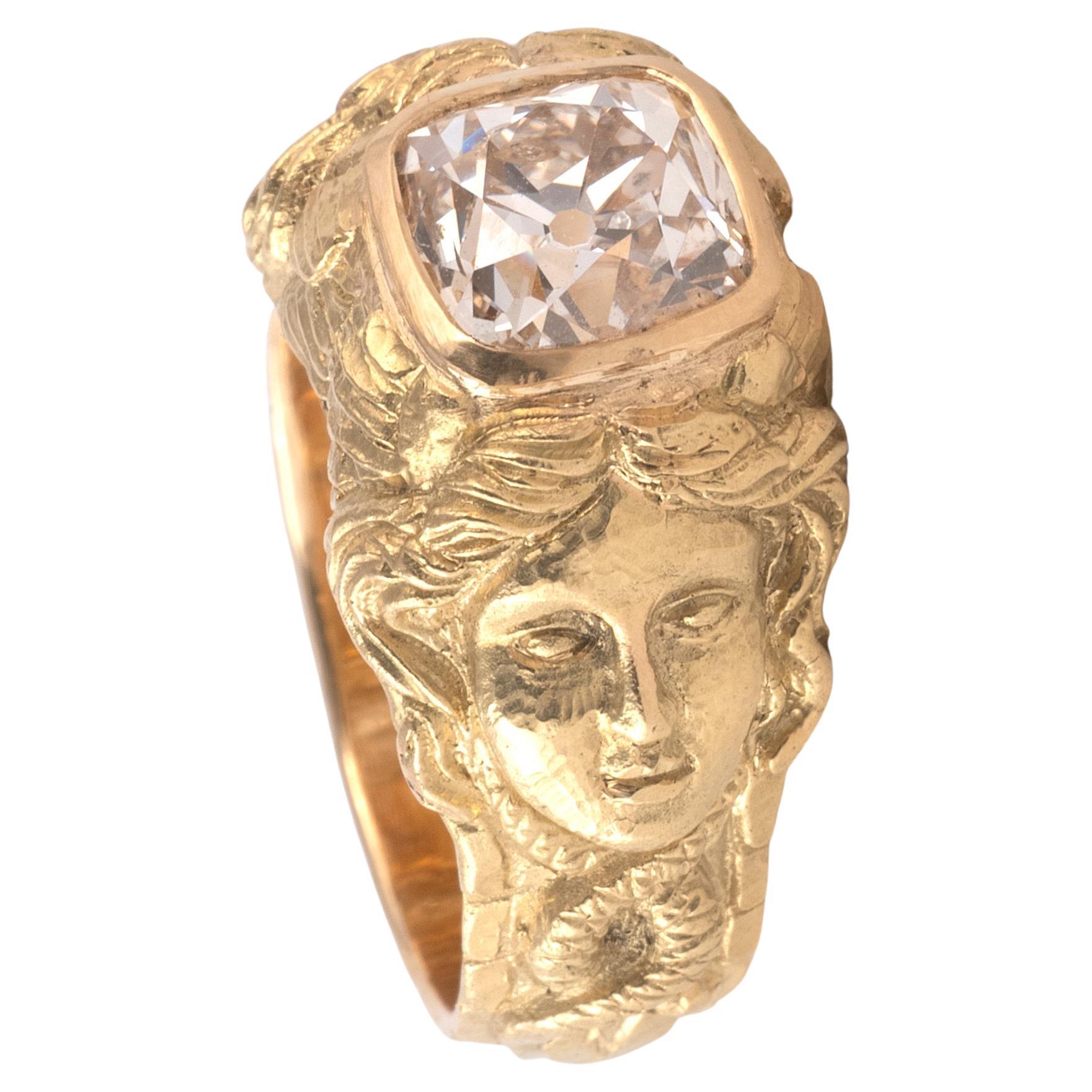 A gorgeous Art Nouveau  c. 1900s figural ring, set with a 2.34 ct old cushion cut diamond in a setting of heavy 18k gold with detailed moulded and chased relief figure of Medusa.
Size: 7
Weight: 13.05gr

Similarly styled Art Nouveau ring settings,