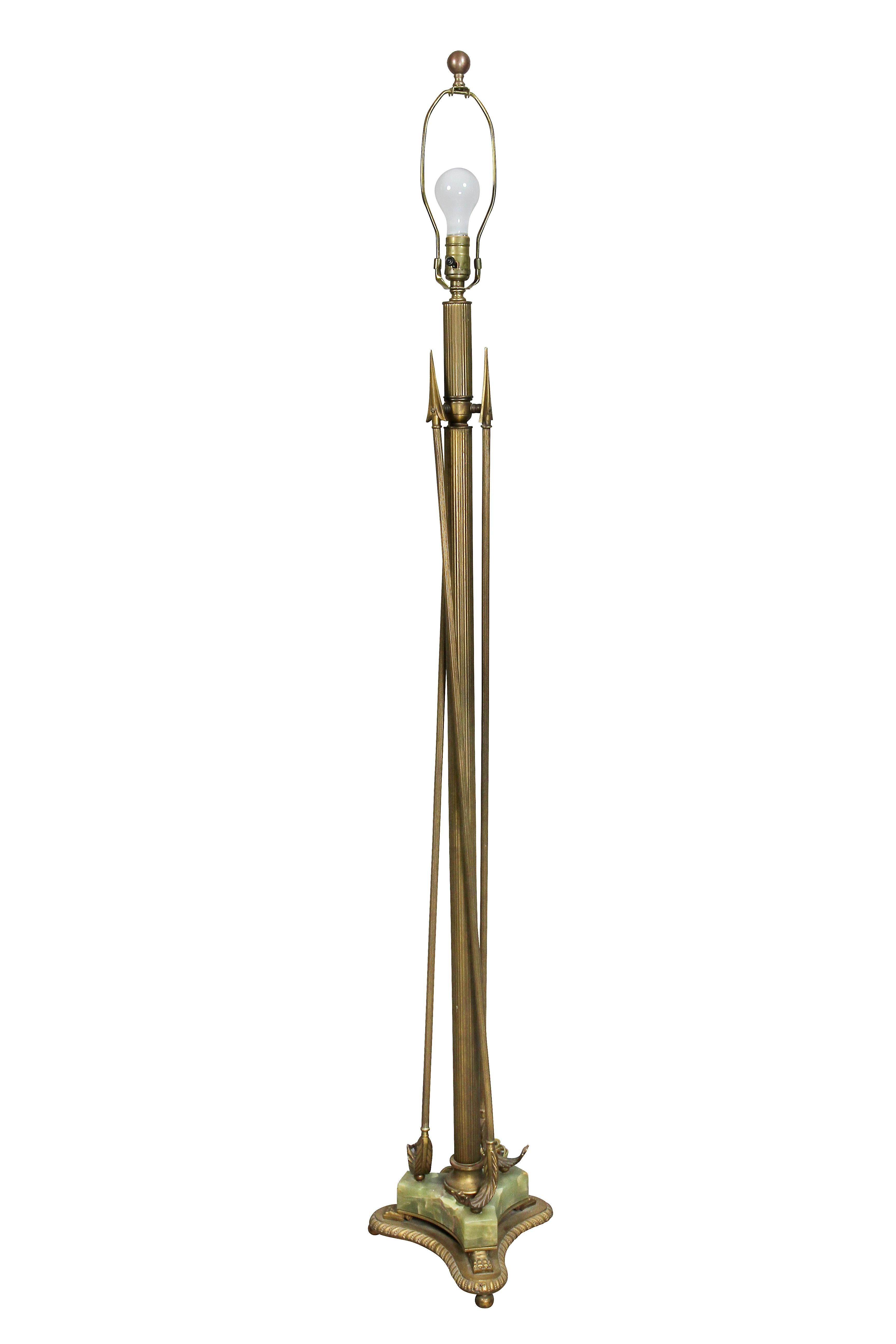With one socket, reeded support with three vertical arrows, triangular onyx base, paw feet and conforming brass base.
