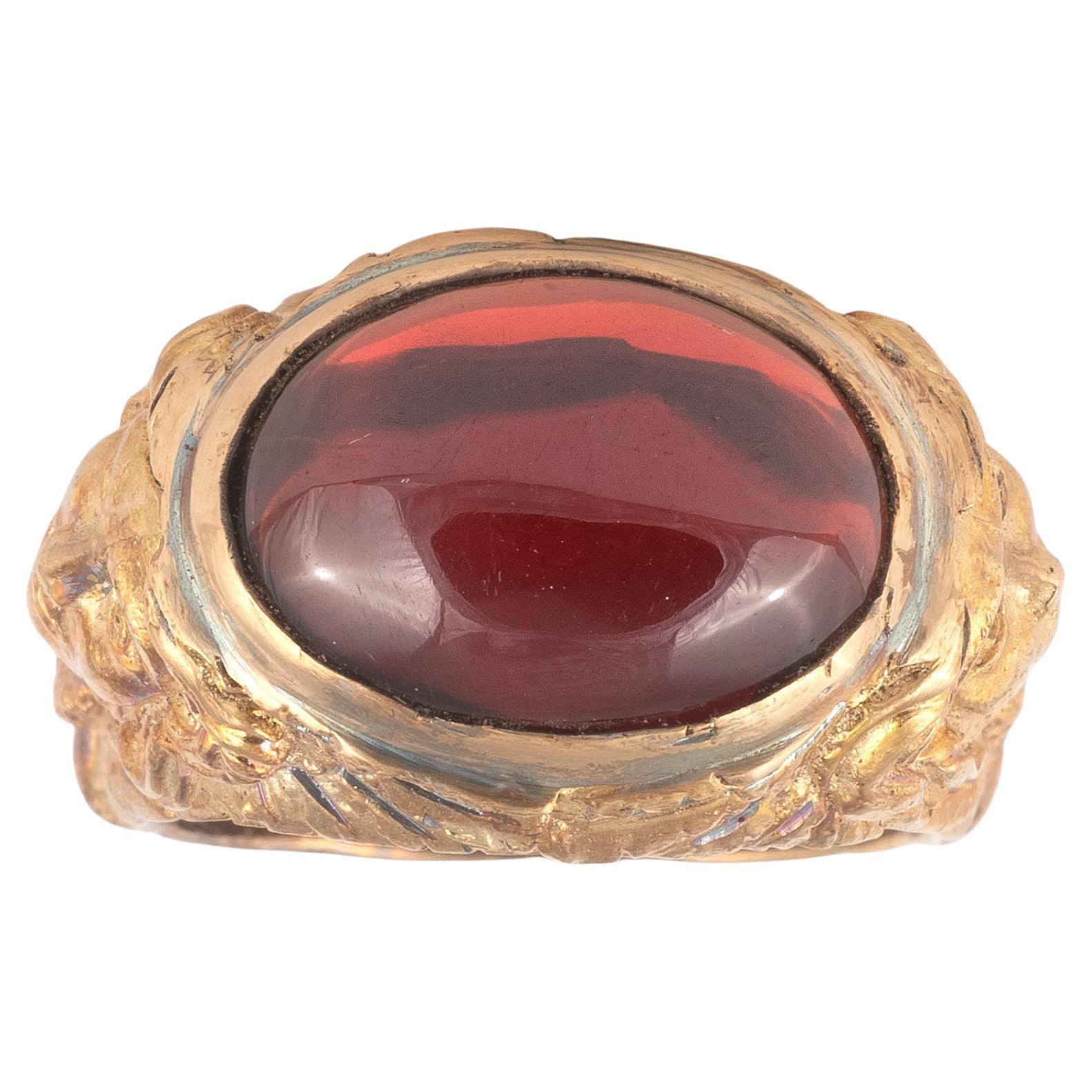 A gorgeous c. 1900s Art Nouveau figural ring, set with a dark red cabochon garnet in a setting of heavy 18k  gold with detailed moulded and chased relief figure of Medusa.
Size: 7
Weight: 13.05gr

Similarly styled Art Nouveau ring settings, all to